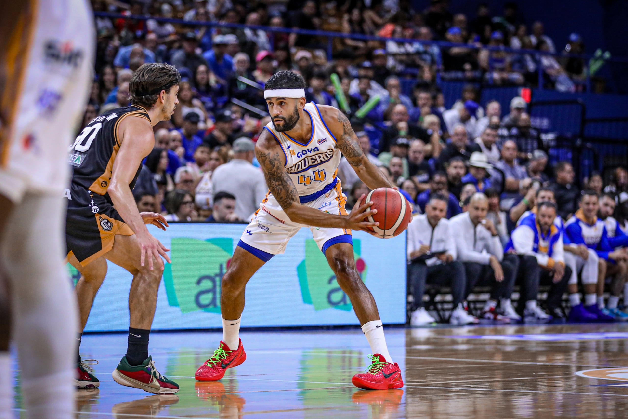Javier Mojica, de los Vaqueros de Bayamón, controla el balón ante la defensa de David Stockton, de los Capitanes de Arecibo, en la temporada 2024 del BSN.