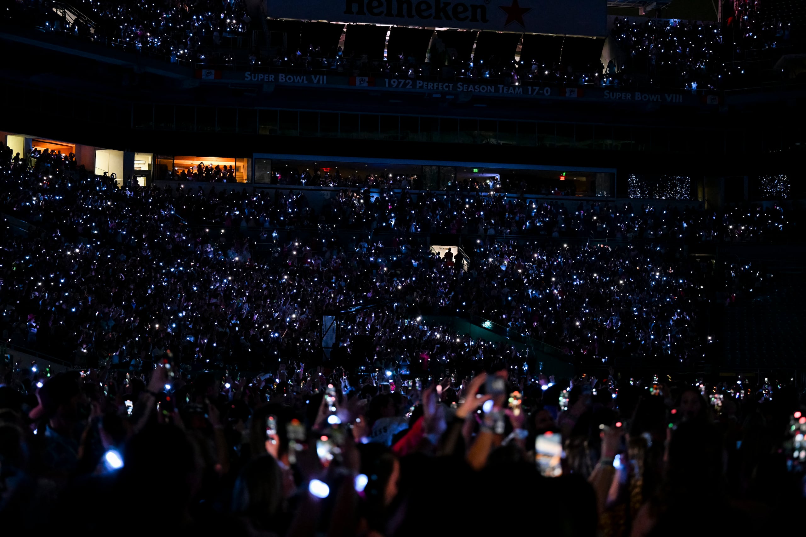 Fans of US singer Taylor Swift cheer during "The Eras Tour" at the Hard Rock stadium in Miami Gardens, Florida, October 18, 2024. (Photo by CHANDAN KHANNA / AFP)