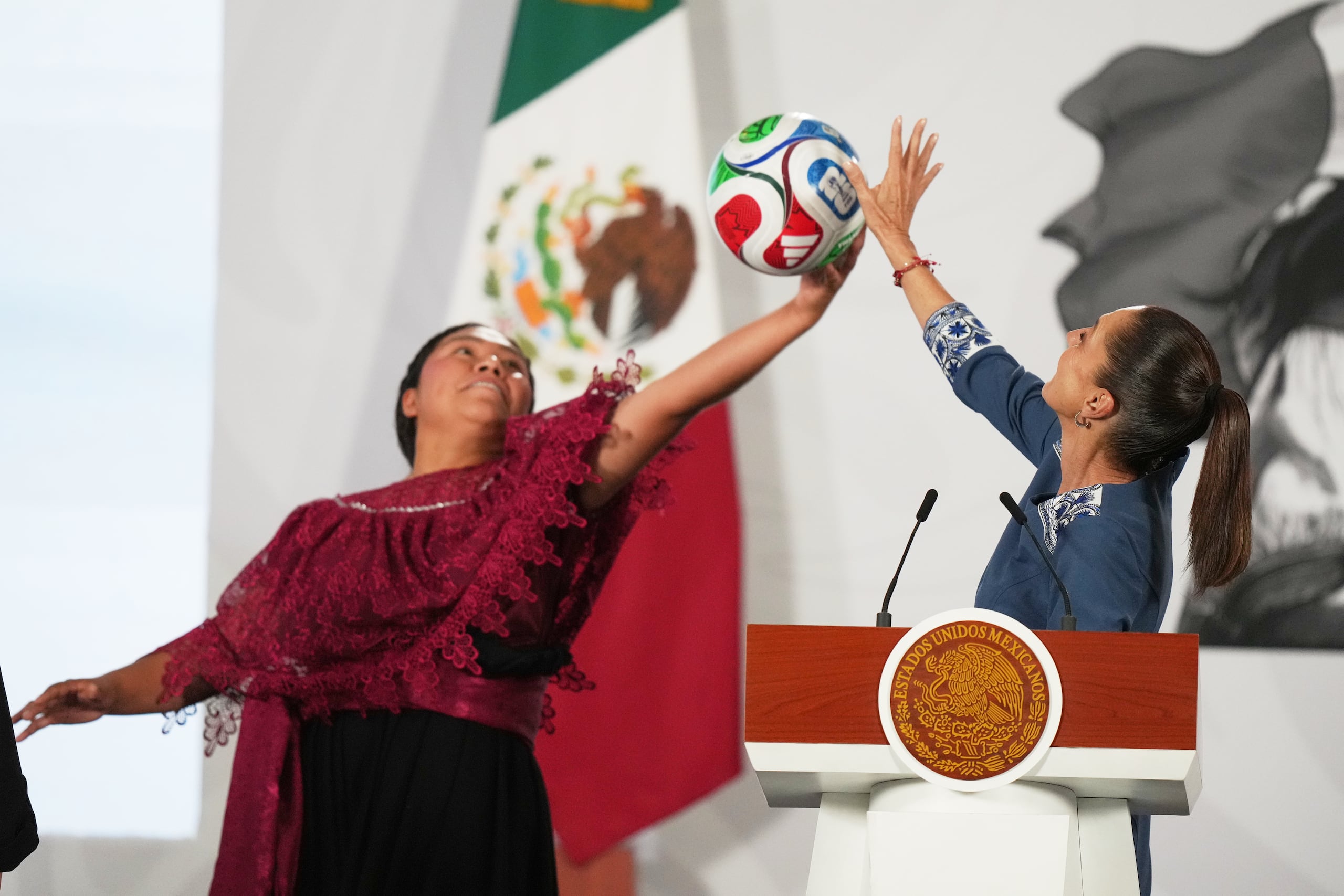 La presidenta mexicana Claudia Sheinbaum, a la derecha, y la futbolista amateur Yolett Cervantes intentan atrapar un balón durante la ceremonia de entrega de boletos para el partido inaugural del Mundial de la FIFA 2026, el 29 de mayo de 2026, en Ciudad de México. (AP Foto/Fernando Llano, archivo)