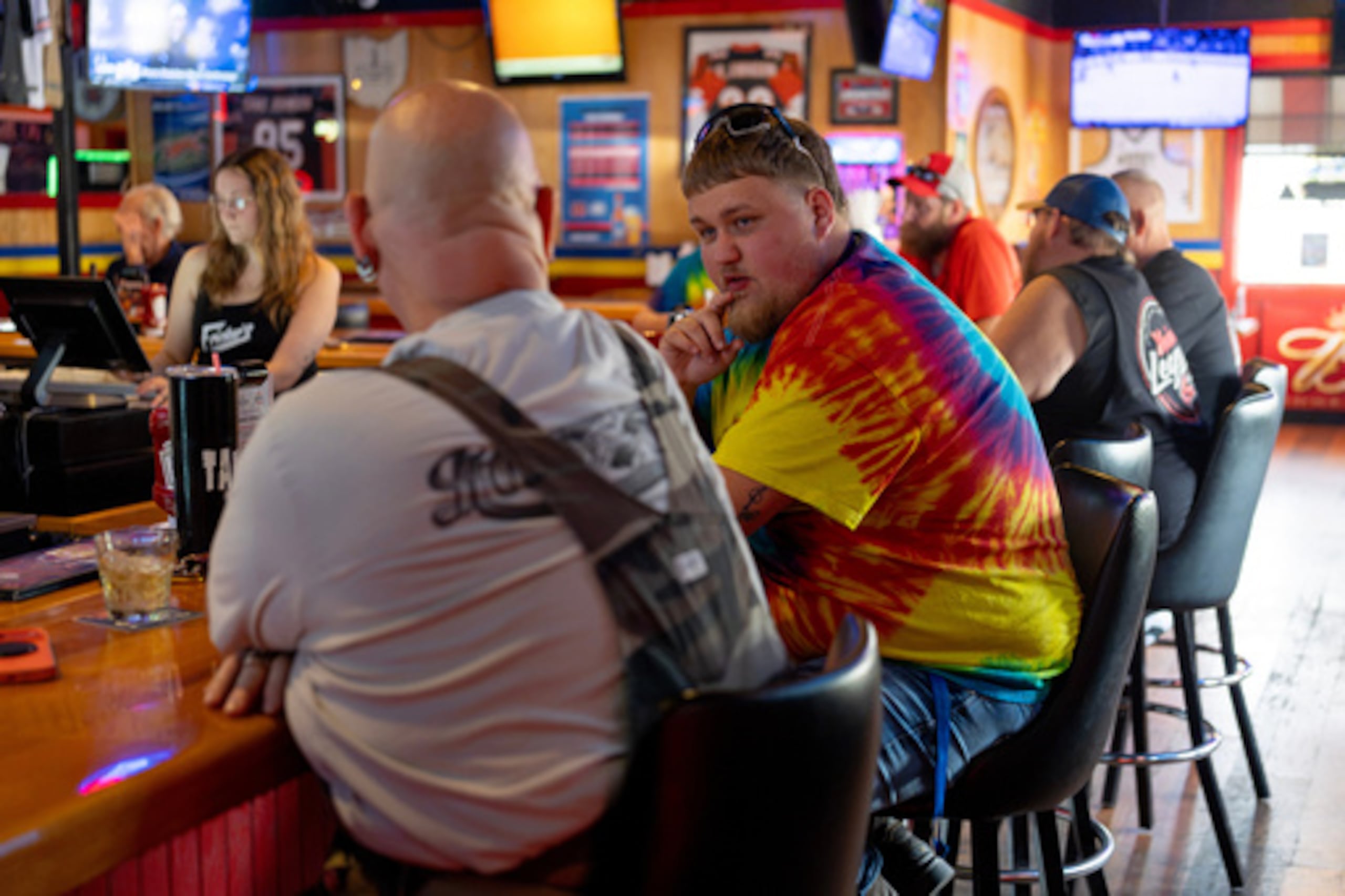 Kyle Bos, miembro del Local 402 del sindicato UAW (a la derecha), toma una cerveza con Hal «Tank» Dunithan, a la izquierda, y otros compañeros del Local 402 de la UAW en el restaurante y bar Fricker's de Springfield (Ohio), el miércoles 30 de septiembre de 2026, el último día de la antigua Navistar en su planta de Springfield. (Foto AP/Carolyn Kaster)