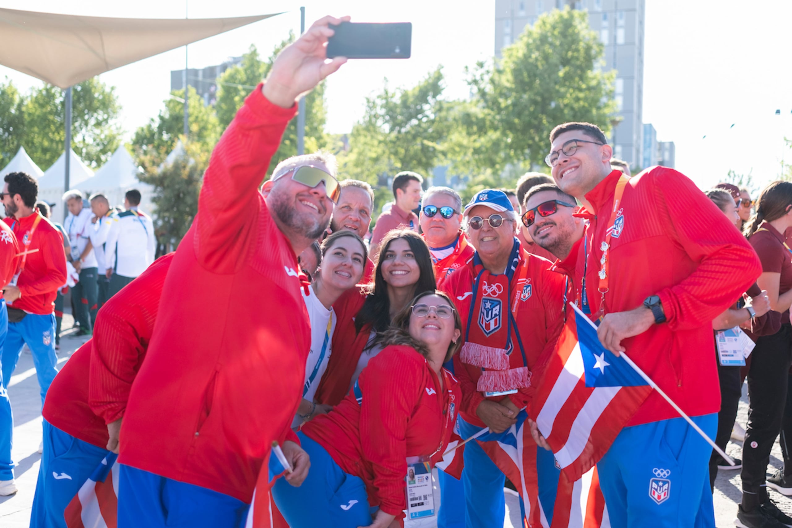 Un grupo de atletas de Puerto Rico se toma un selfie tras la ceremonia de izamiento de banderas. (Luis Licona / Straffon Images)