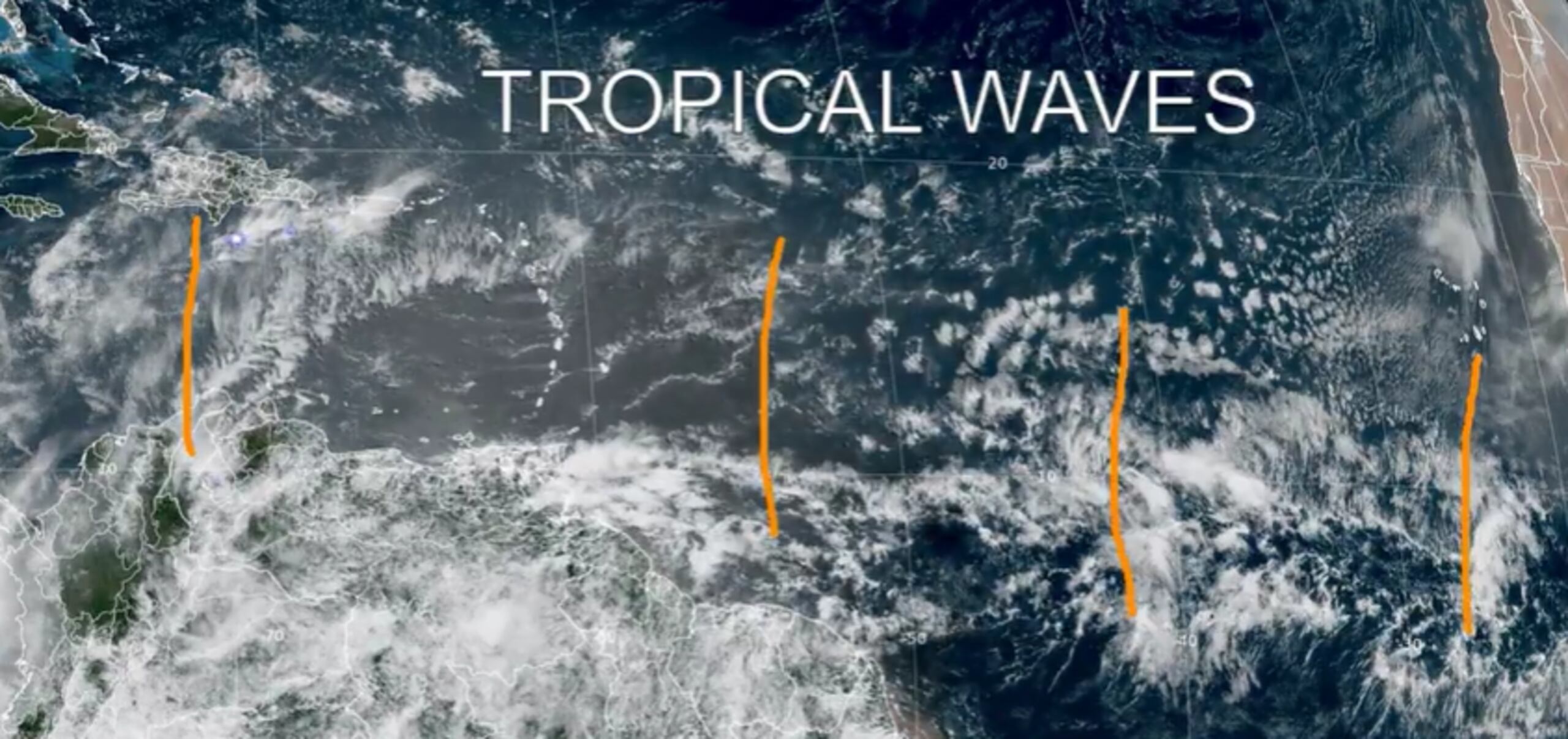 Imagen satelital de la zona del Caribe y el océano Atlántico que muestra con marcas anaranjadas las ondas tropicales bajo vigilancia.