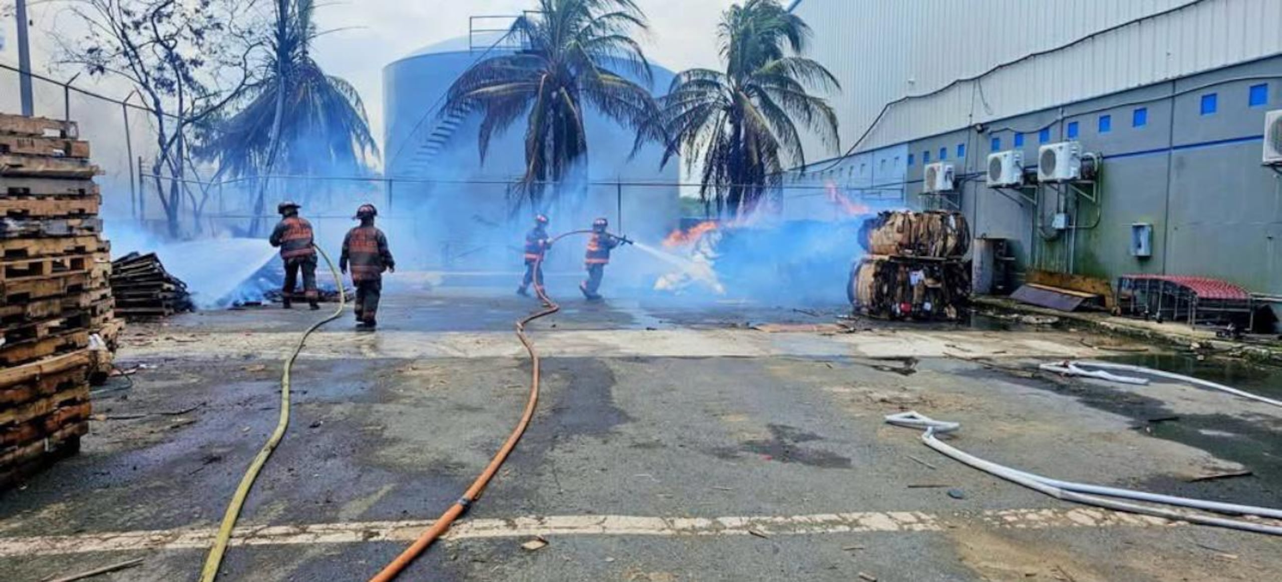 Bomberos trabajan en la extinción de un incendio reportado en un almacén de la Zona de Libre Comercio en Guaynabo.