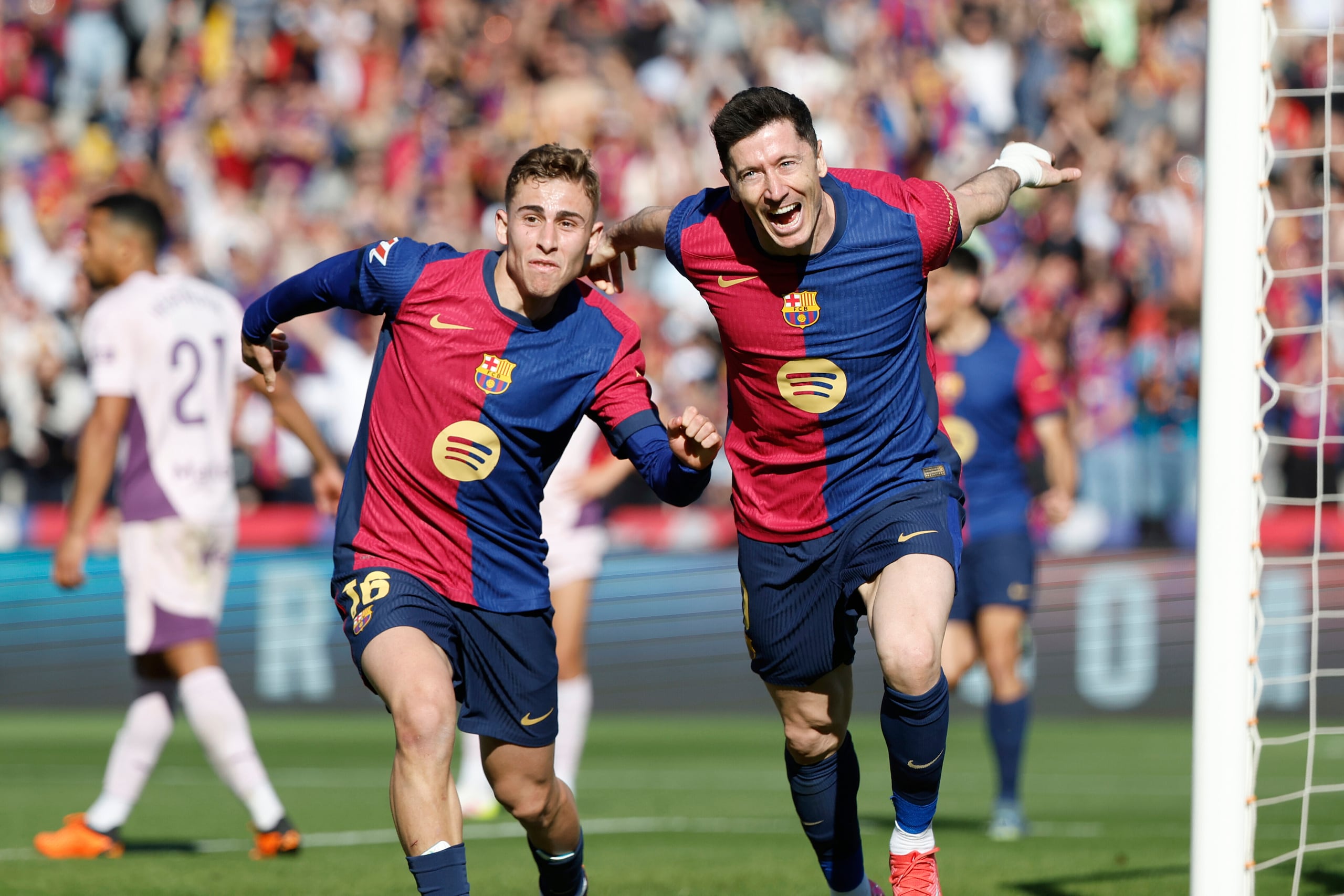 Robert Lewandowski, del Barcelona, a la derecha, celebra tras anotar en el encuentro ante el Girona en la liga española el domingo 30 de marzo del 2025.