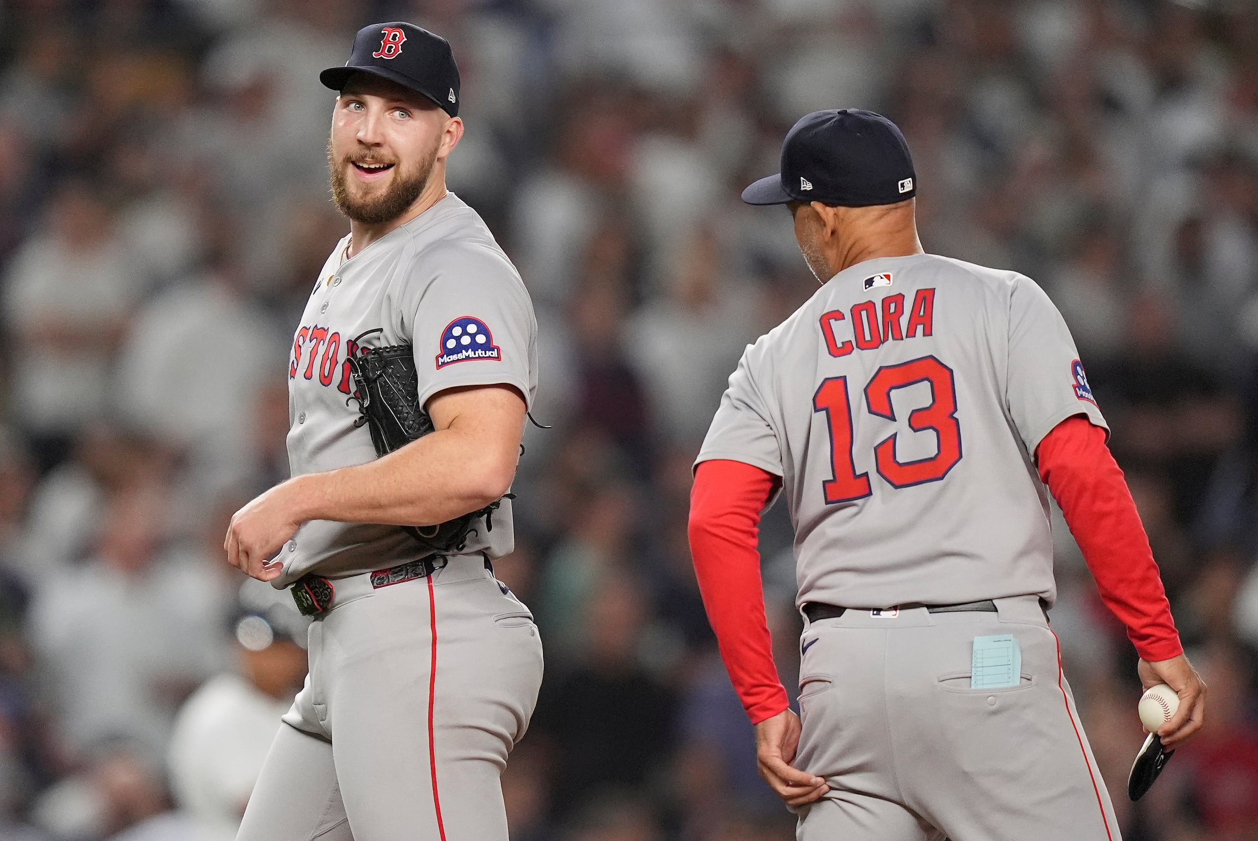 El lanzador Garrett Crochet, de los Red Sox de Boston, charla con el mánager boricua Alex Cora durante el octavo inning del primer juego de la serie de comodines de la Liga Americana contra los Yankees de Nueva York.