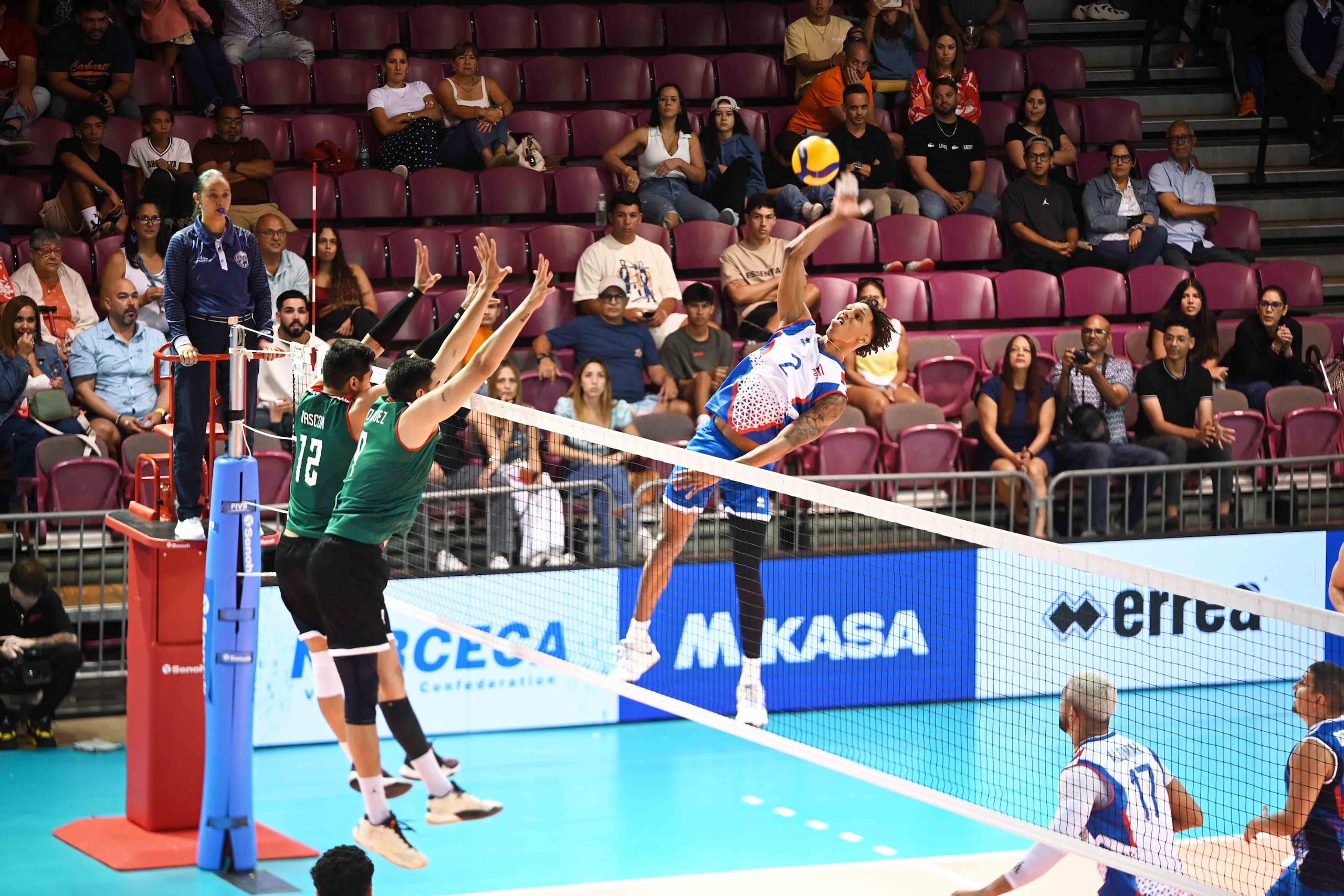 Klistan Lawrence, de Puerto Rico, ataca alto y cruzado ante el bloqueo montado de México para defender la diagonal durante la acción del domingo en Ponce.