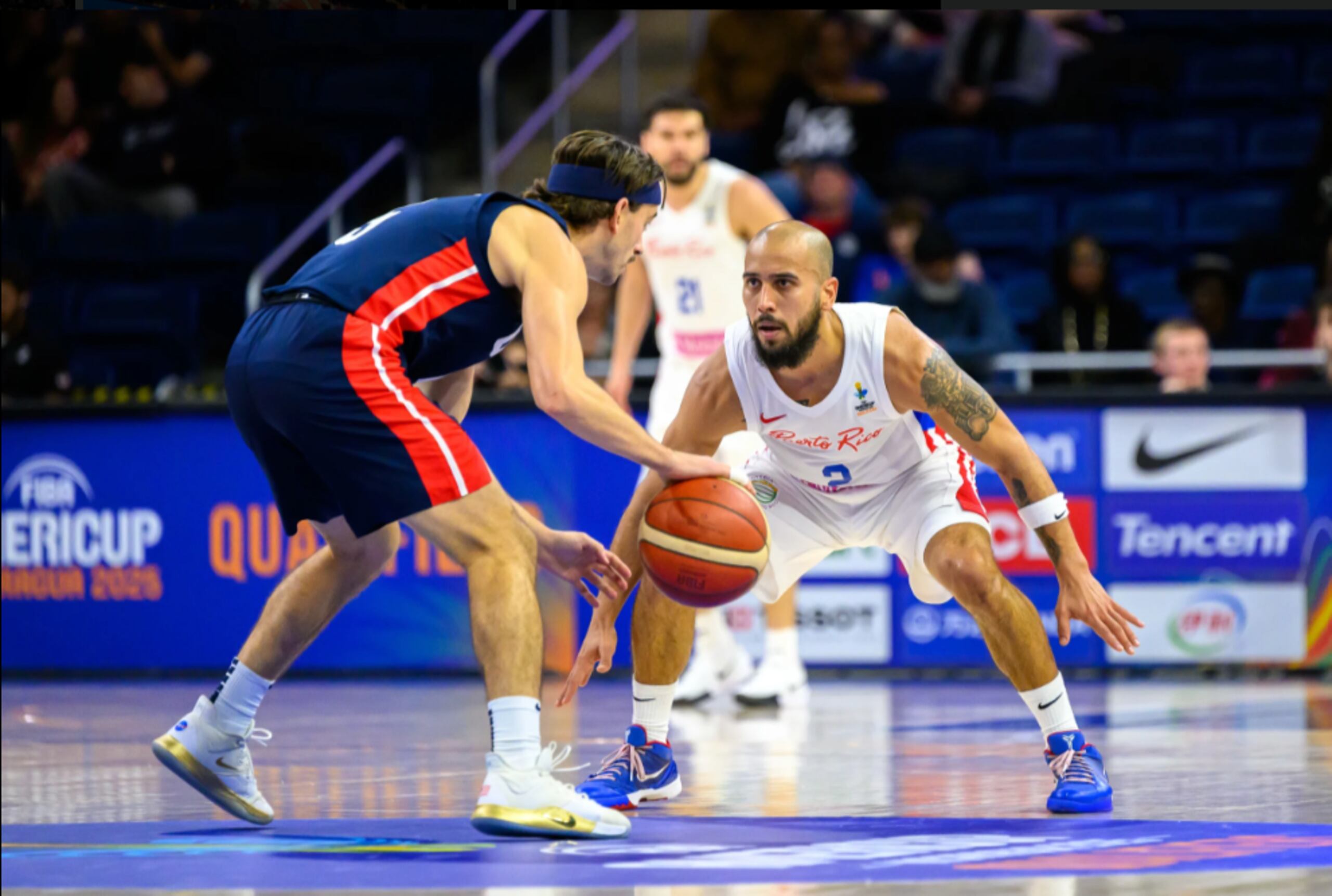 Tjader Fernández defiende a David Stockton en el inicio de la segunda ventana clasificatoria al AmeriCup 2025 entre Puerto Rico y Estados Unidos.