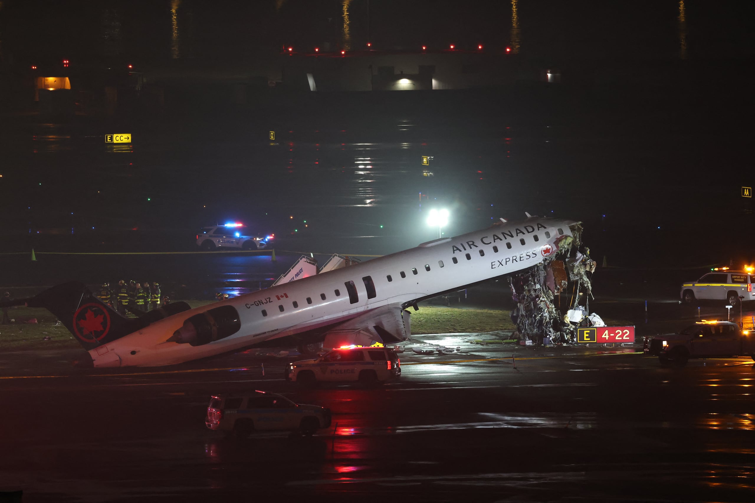 An Air Canada Express CRJ-900 sits on the runway after colliding with a Port Authority fire truck at LaGuardia Airport in New York, on March 23, 2026. Air Canada Express flight AC8646 originated from Montreal and collided with the fire truck during landing. (Photo by ANGELA WEISS / AFP)