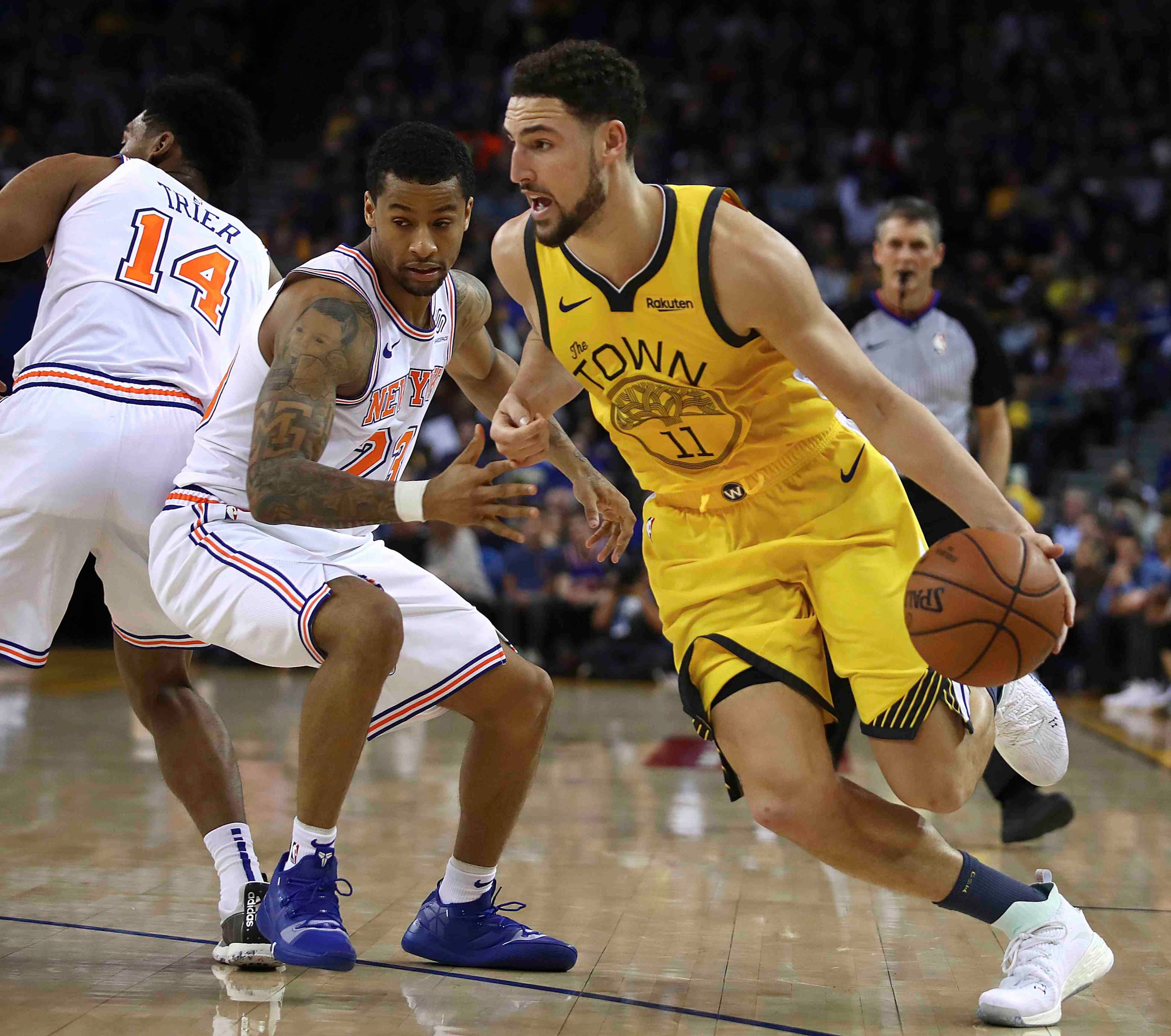 Klay Thompson maneja el balón contra Trey Burke. (AP)