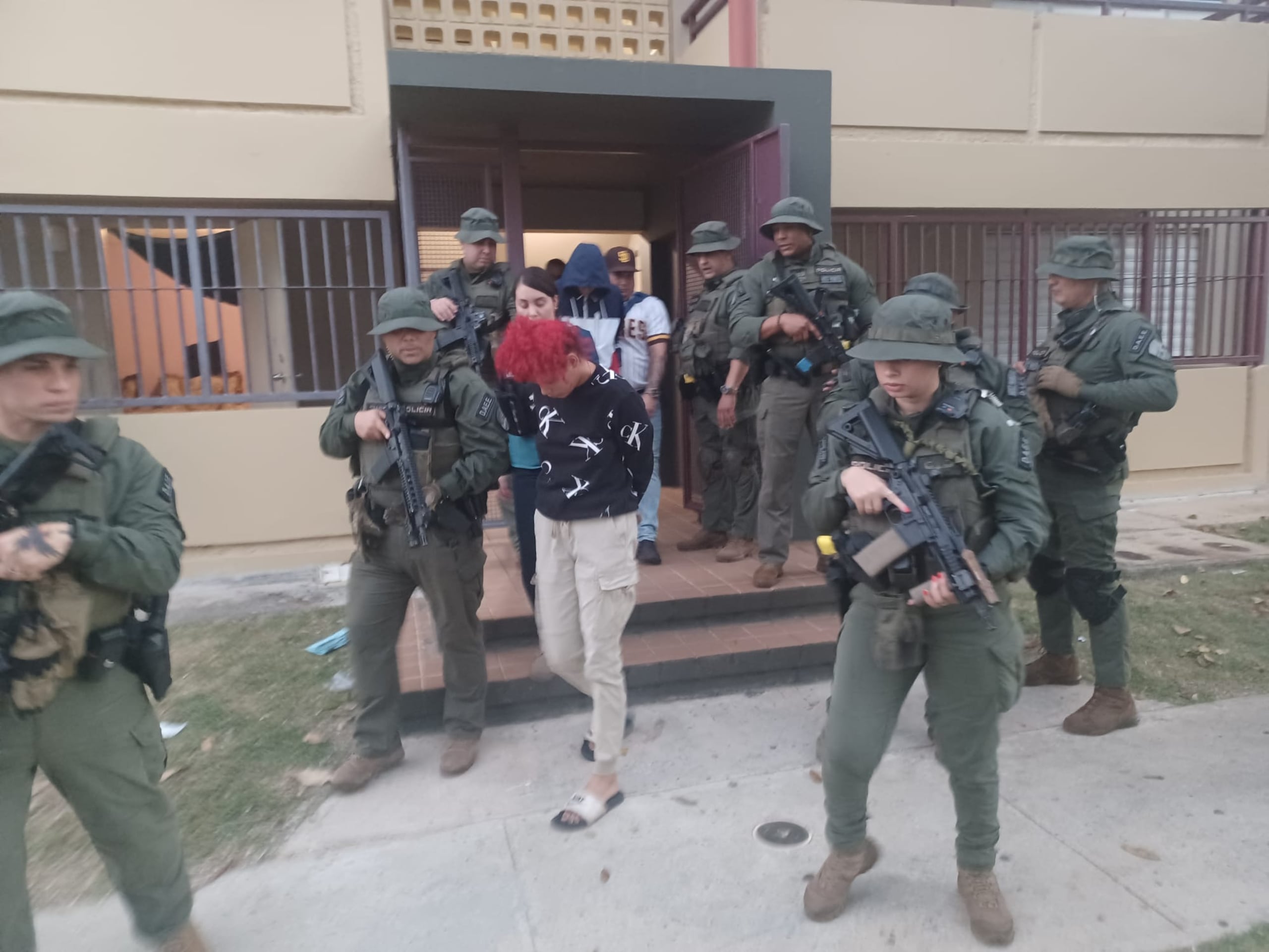 Salida de varios arrestados durante el diligenciamiento de órdenes de allanamiento en el residencia Pedro Rosario Nieves, en Fajardo.