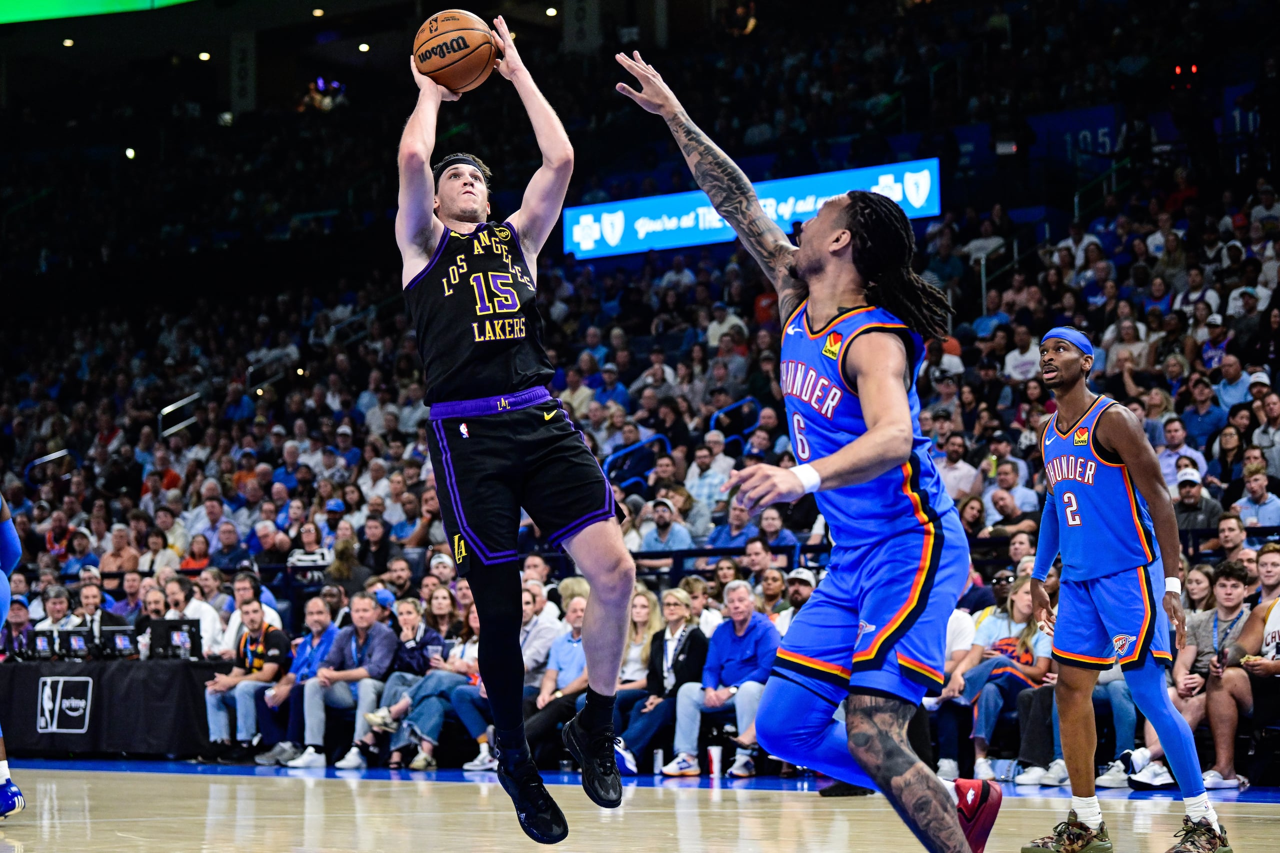 Austin Reaves, de los Lakers de Los Ángeles, lanza ante la defensa de Jaylin Williams, del Thunder de Oklahoma City.