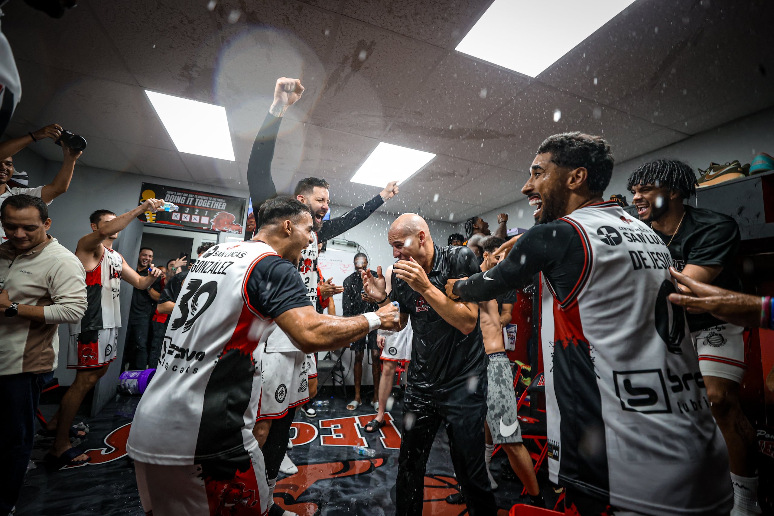 Carlos Rivera es recibido en el camerino local del Auditorio Juan "Pachín" Vicens por los jugadores de los Leones de Ponce tras ganar la final de la Conferencia B del BSN contra los Indios de Mayagüez.