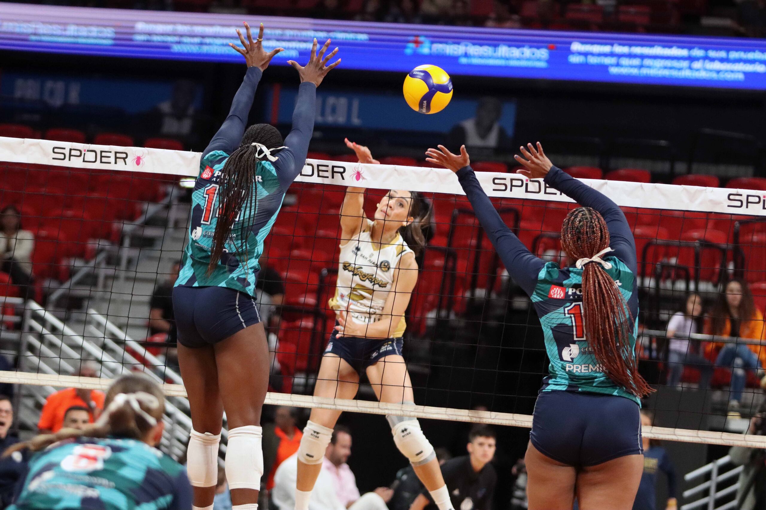 Andrea Rangel, de las Cangrejeras de Santurce, logra un ataque contra la defensa de las Criollas de Caguas en el primer juego de la final de la LVSF.