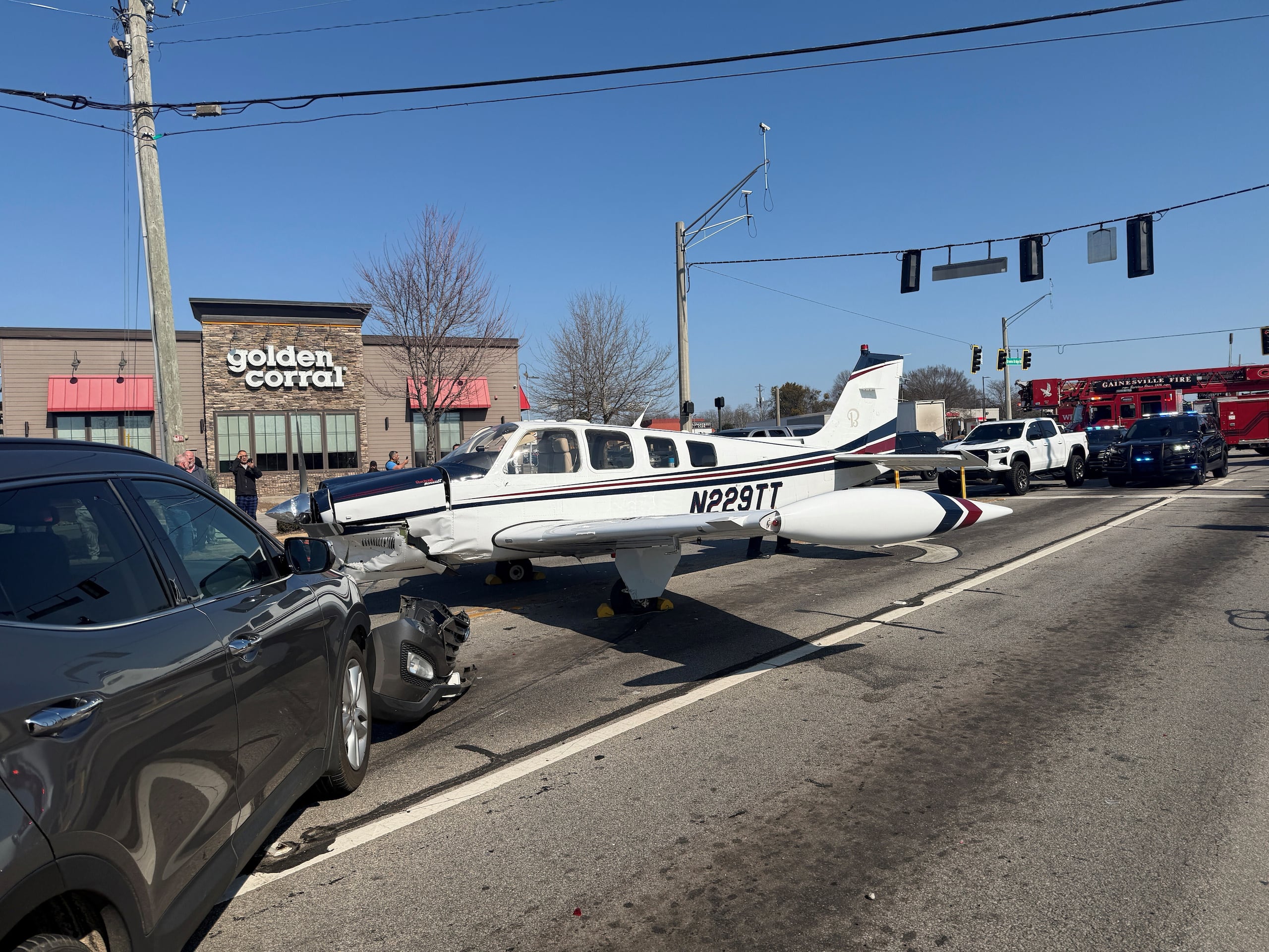 This image provided by Gainesville Police Department shows a small plane that made an emergency landing on a street in Gainesville, Ga., Monday, Feb. 9, 2026. (Gainesville, Ga., Police Department via AP)