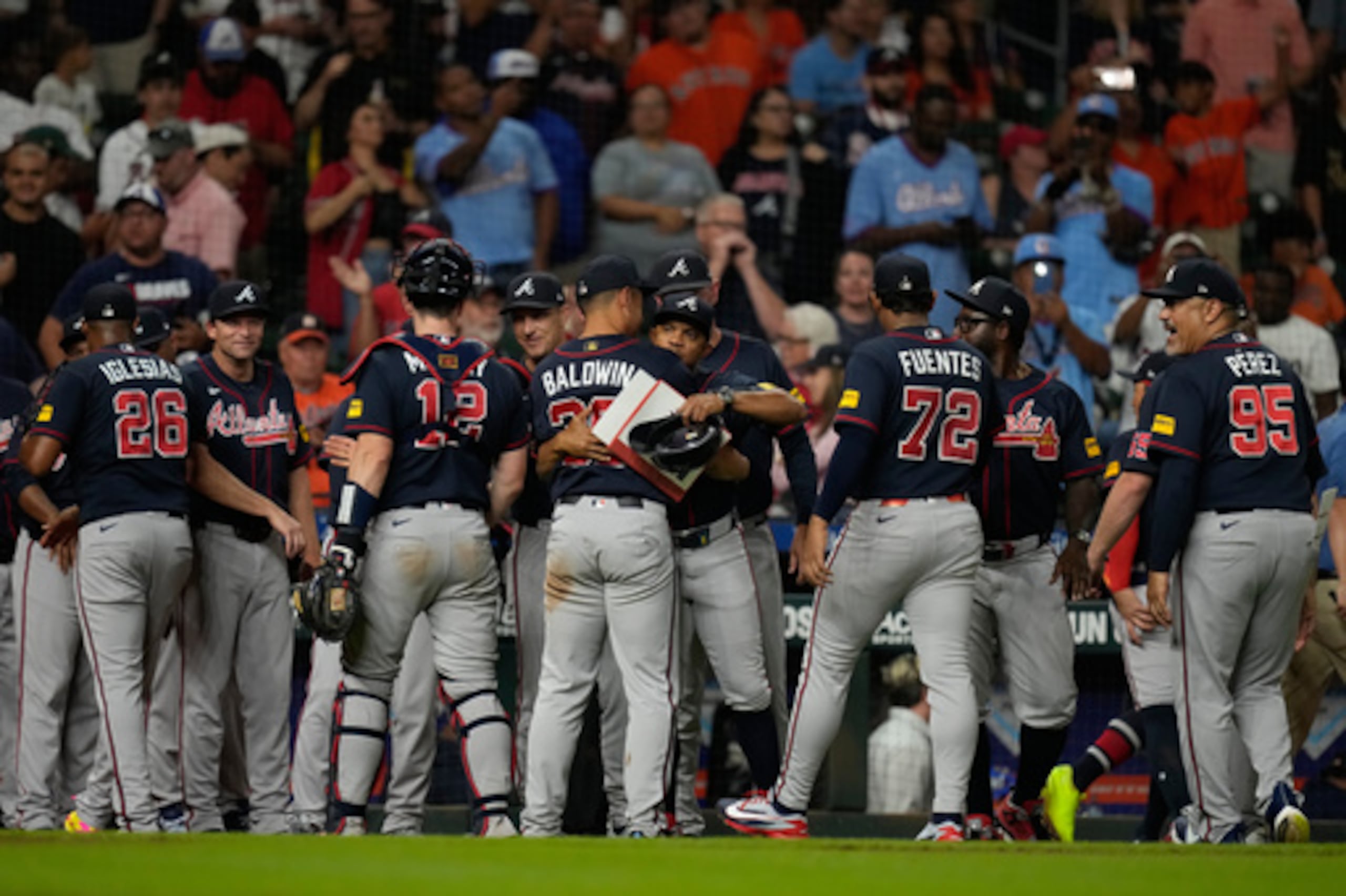 Atlanta Braves players and staff celebrate after winning a baseball game against the Houston Astros in Houston, Friday, Sept. 18, 2026. (AP Photo/Ashley Landis)