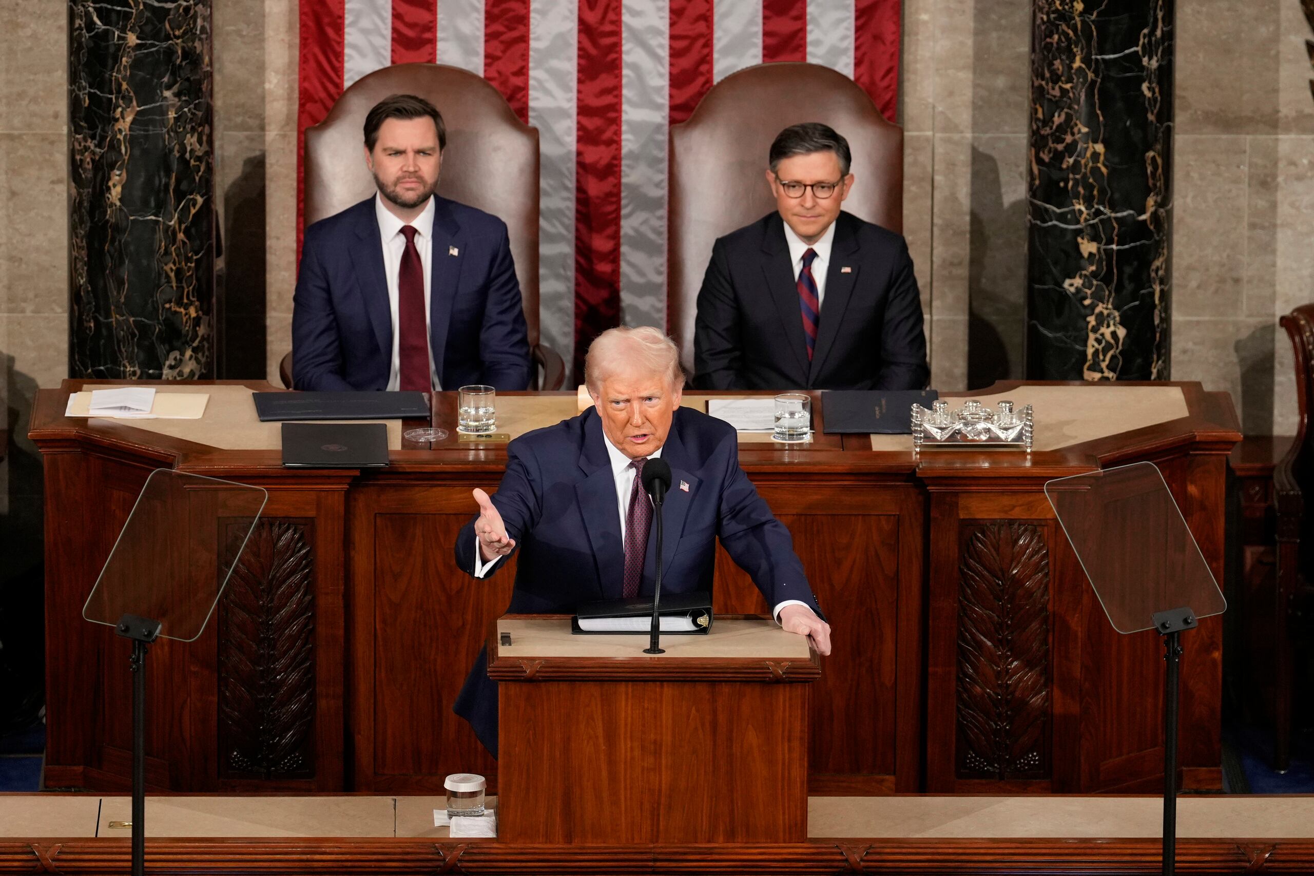 House Speaker Mike Johnson of La., right, and Vice President JD Vance, left, listen as President Donald Trump addresses a joint session of Congress at the Capitol in Washington, Tuesday, March 4, 2025. (AP Photo/Ben Curtis)