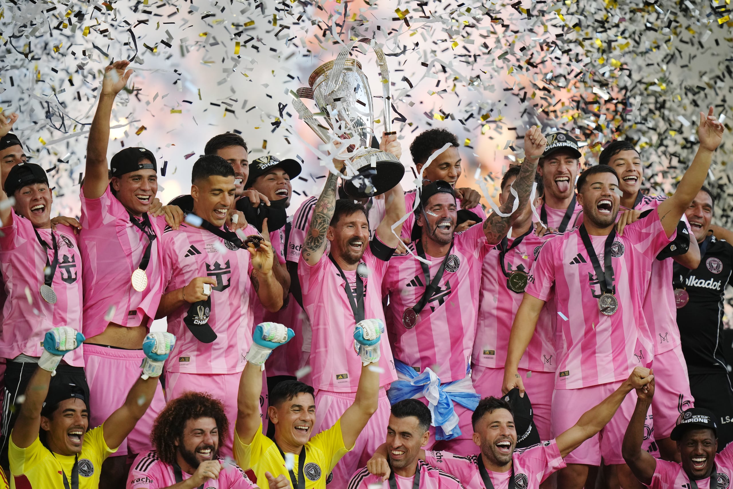 Inter Miami's Lionel Messi hoists the trophy alongside teammates after defeating the Vancouver Whitecaps in the MLS Cup final soccer match, in Fort Lauderdale, Fla., Saturday, Dec. 6, 2025. (Darryl Dyck/The Canadian Press via AP)