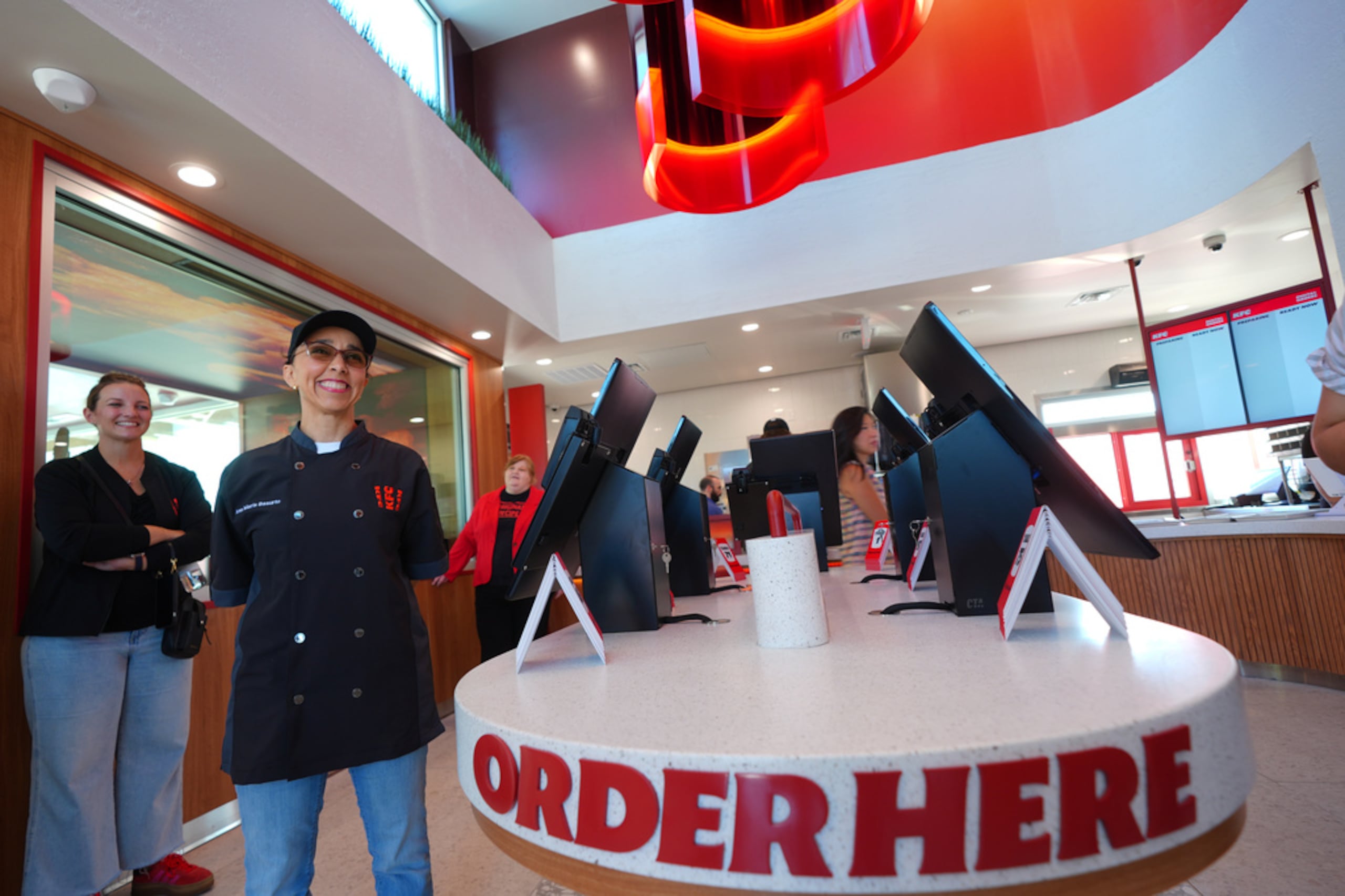 Ana Maria Basurto, a la izquierda, sonríe antes de hablar sobre el nuevo restaurante KFC en McKinney, Texas.