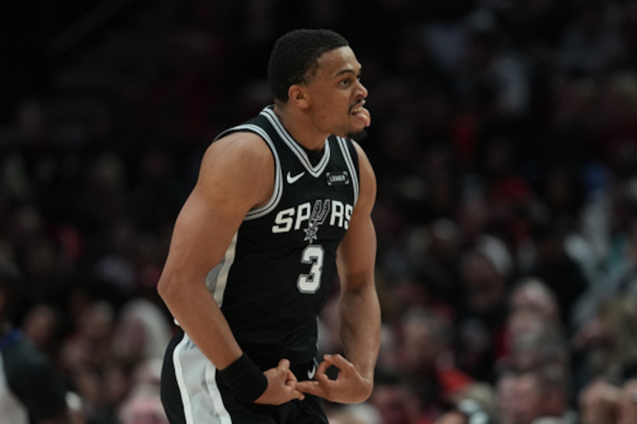 El alero de los San Antonio Spurs Keldon Johnson (3) reacciona tras anotar contra los Portland Trail Blazers durante la segunda mitad del tercer partido de la primera ronda de los playoffs de baloncesto de la NBA en Portland, Oregón, el viernes 24 de abril de 2026. (AP Photo/Jenny Kane)