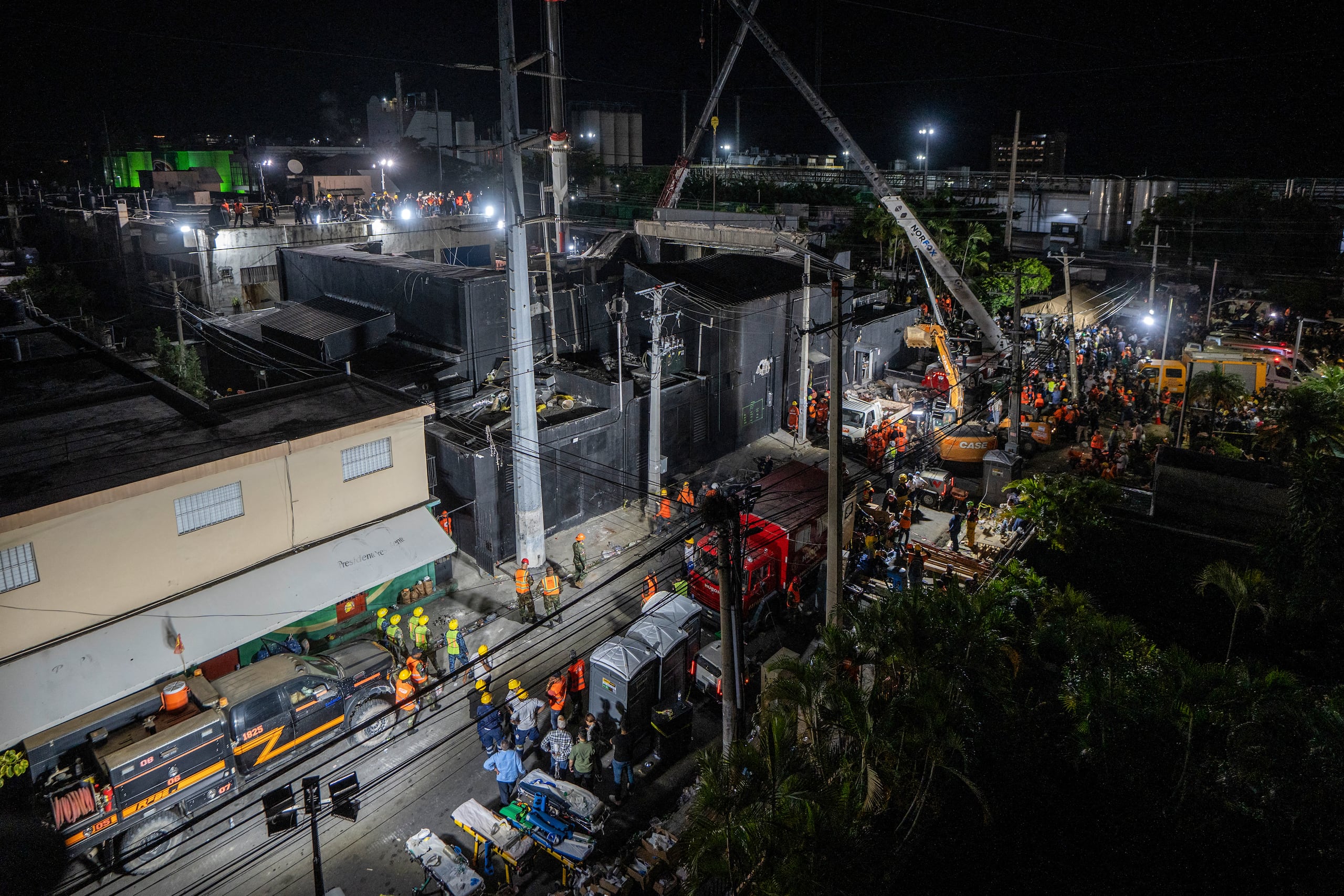 Rescue teams work at the Jet Set nightclub following the collapse of its roof in Santo Domingo on April 8, 2025. Rescuers raced to find survivors on April 8, 2025, among the rubble of a Dominican Republic nightclub where at least 79 people, including a former Major League Baseball star, were killed when the roof collapsed. (Photo by Francesco SPOTORNO / AFP)