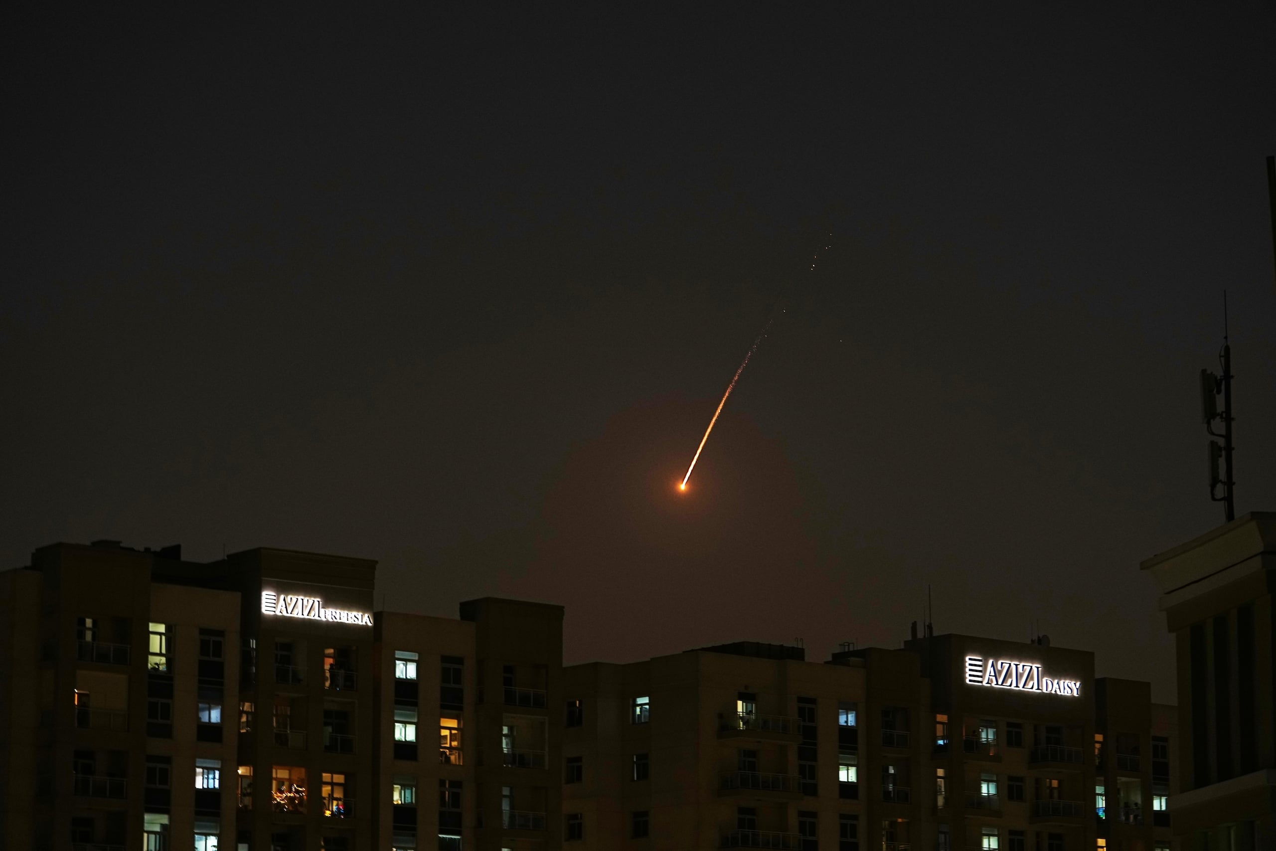 The flare of a projectile is seen over the skyline of Dubai, United Arab Emirates, Saturday, Feb. 28, 2026. (AP Photo/Fatima Shbair)