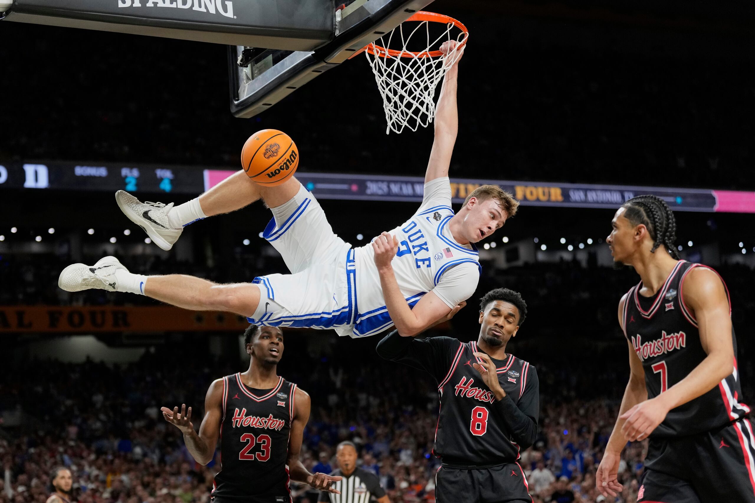 En esta foto del 5 de abril del 2025, Cooper Flagg, de Duke, observa atrás tras donquear el balón frente a Terrance Arceneaux, Mylik Wilson y Milos Uzan de Houston en el Final Four de la NCAA.