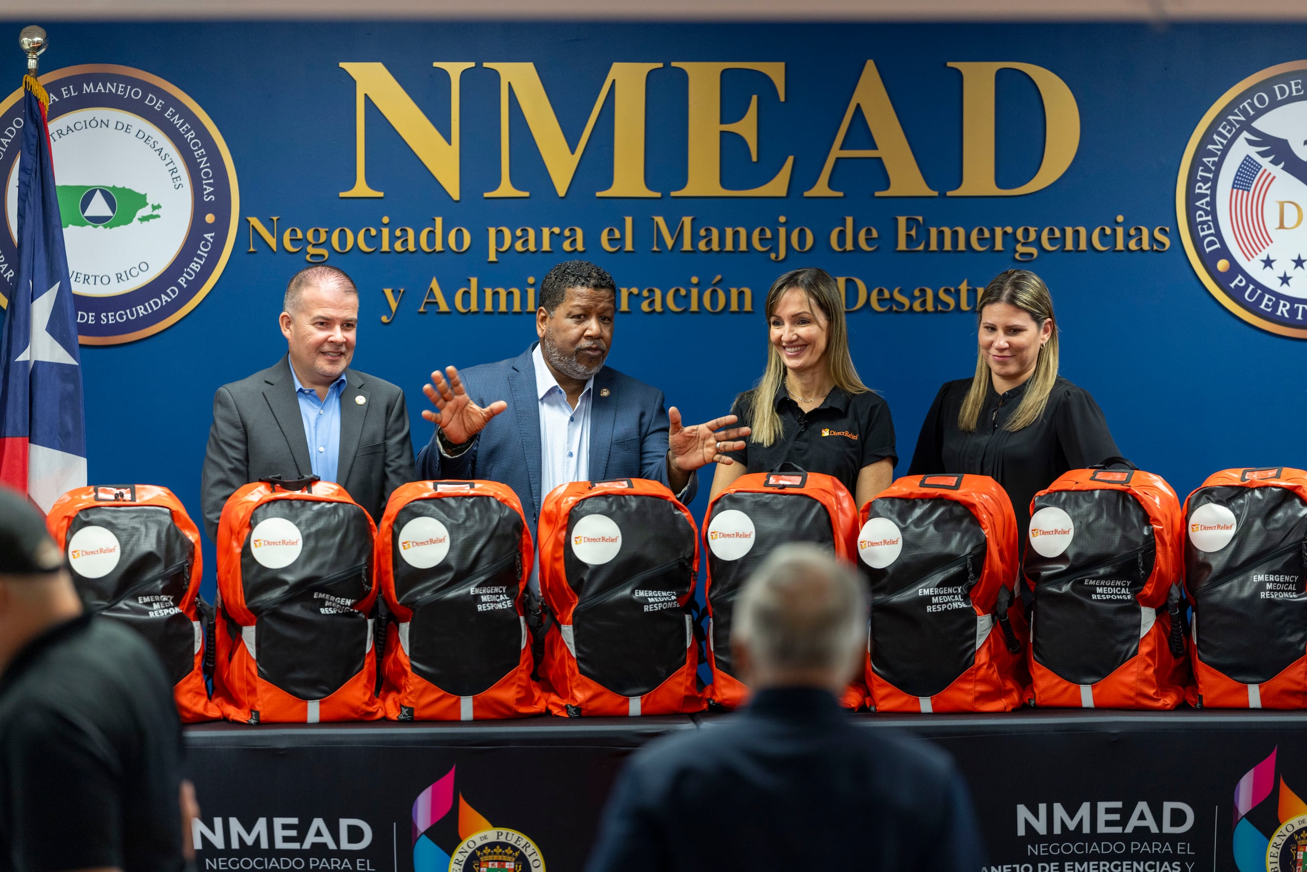 Nino Correa, comisionado del Negociado de Manejo de Emergencias y Administración de Desastres (NMEAD), y Javier Rodríguez , comisionado Negociado del Cuerpo de Emergencias Médicas (MCEM), al momento de recibir las mochilas de manos de Ivonne Rodríguez-Wiewall, asesora ejecutiva de Direct Relief en Puerto Rico.
