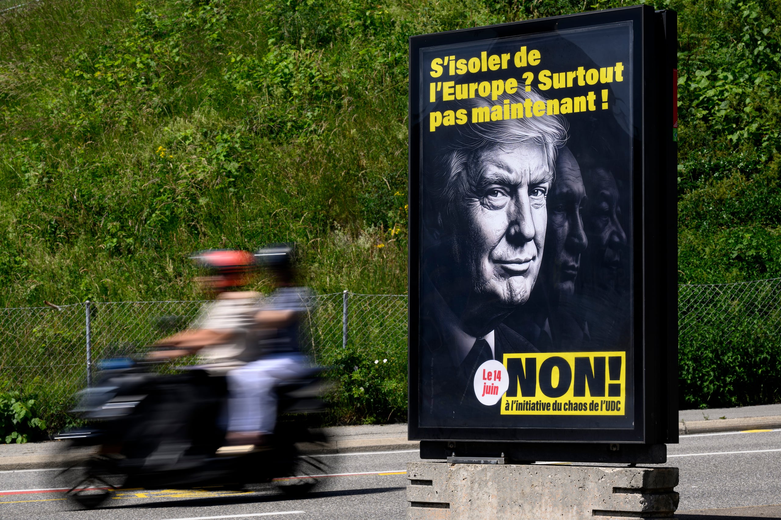 Un cartel con el mensaje "¿Aislarnos de Europa? ¡Desde luego ahora no! No a la iniciativa del caos de SVP/UDC", con las imágenes del presidente de Estados Unidos, Donald Trump; el presidente de Rusia, Vladímir Putin, y el presidente de China, Xi Jinping, para instar a la gente a votar contra la propuesta del Partido Popular Suizo (SVP) de limitar la población, en Lausana, el 27 de mayo de 2026. (Laurent Gillieron/Keystone via AP)