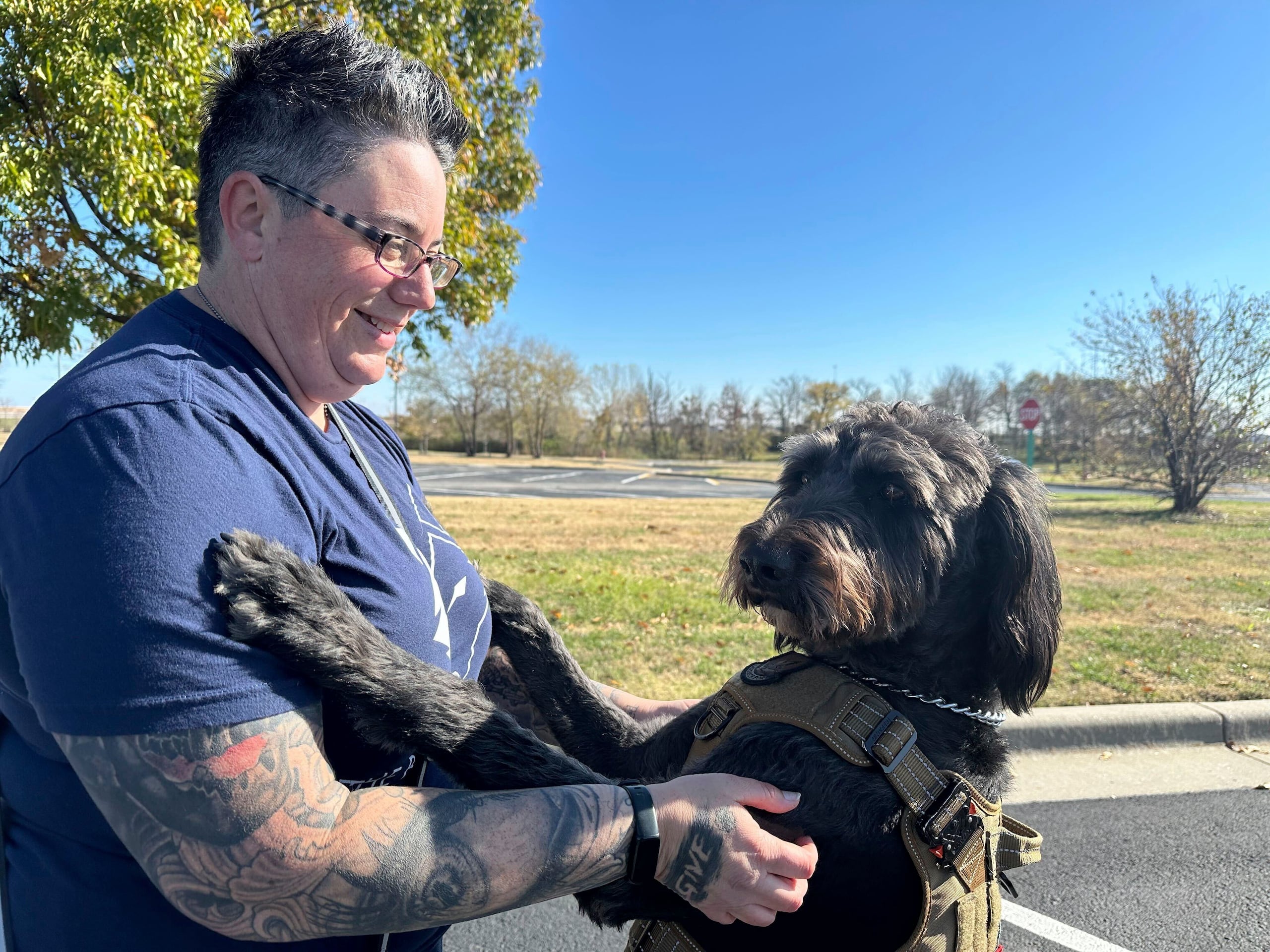 La sargento retirada de la Fuerza Aérea, Heather O'Brien, sostiene a su labradoodle Albus.