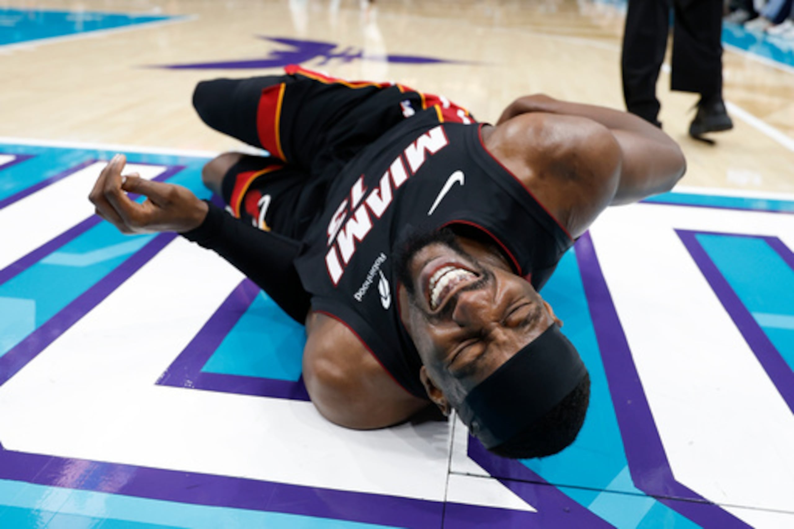 El pívot de los Miami Heat Bam Adebayo (13) se tumba en la cancha durante la primera parte de un partido de baloncesto del torneo de play-in de la NBA contra los Charlotte Hornets en Charlotte, Carolina del Norte, el martes 14 de abril de 2026. (AP Photo/Nell Redmond)