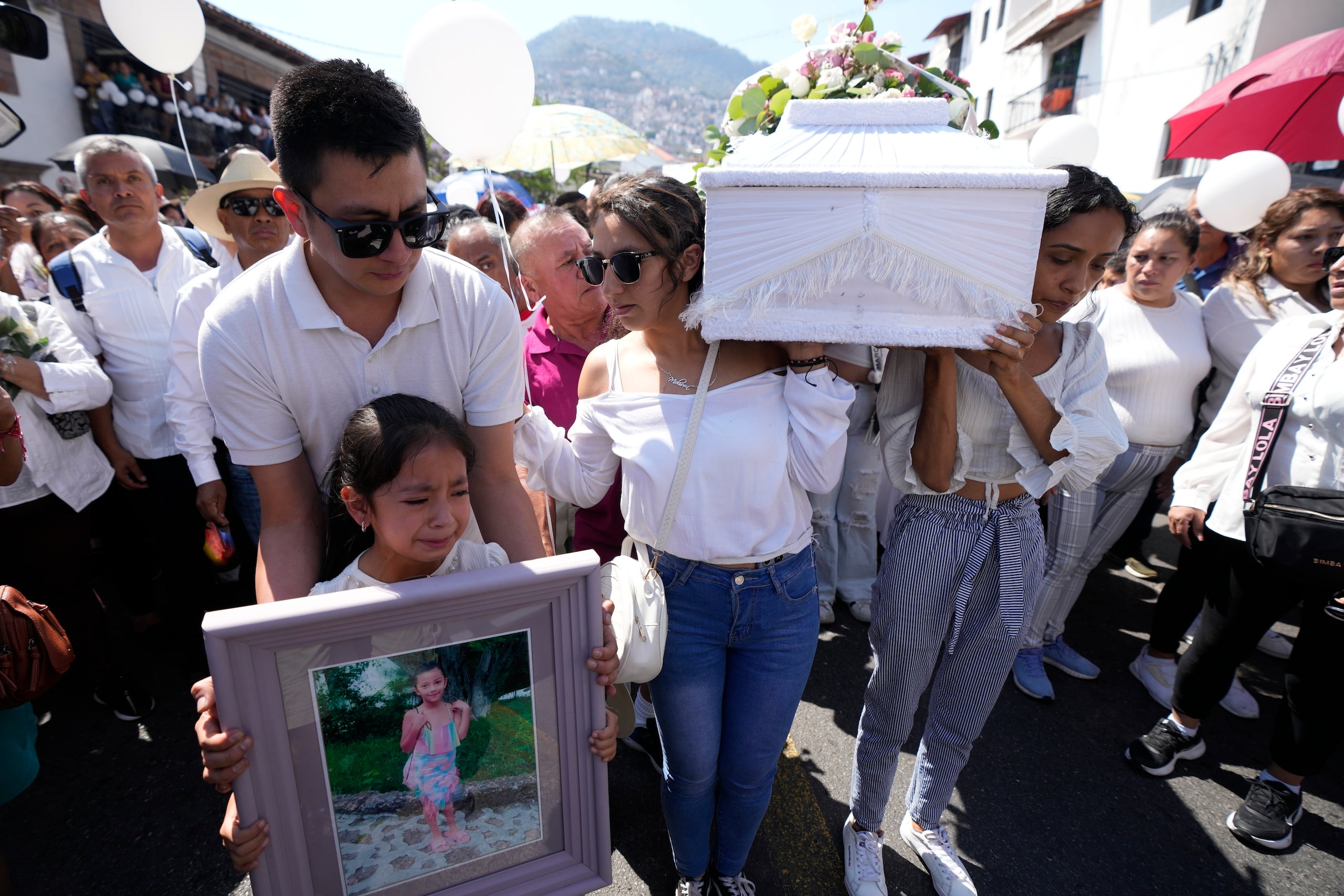 Relatives carry the coffin that contain the remains of a young girl named Camila, in Taxco, Mexico, Friday, March 29, 2024. The 8-year-old girl disappeared Wednesday; her body was found on a road on the outskirts of the city early Thursday. Later that day a mob beat a woman to death because she was suspected of kidnapping and killing the young girl. (AP Photo/Fernando Llano)