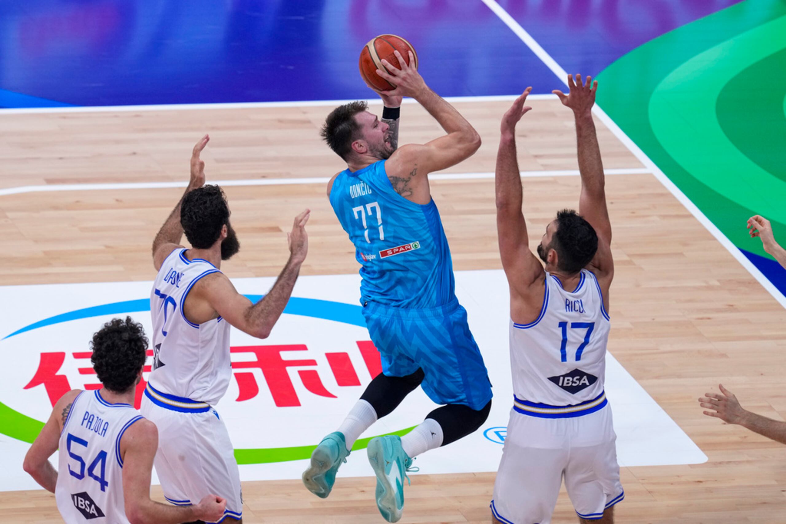 El base de Eslovenia Luka Doncic lanza el balón sobre el italiano Giampaolo Ricci en el encuentro de la Copa Mundial de Baloncesto en Manila.