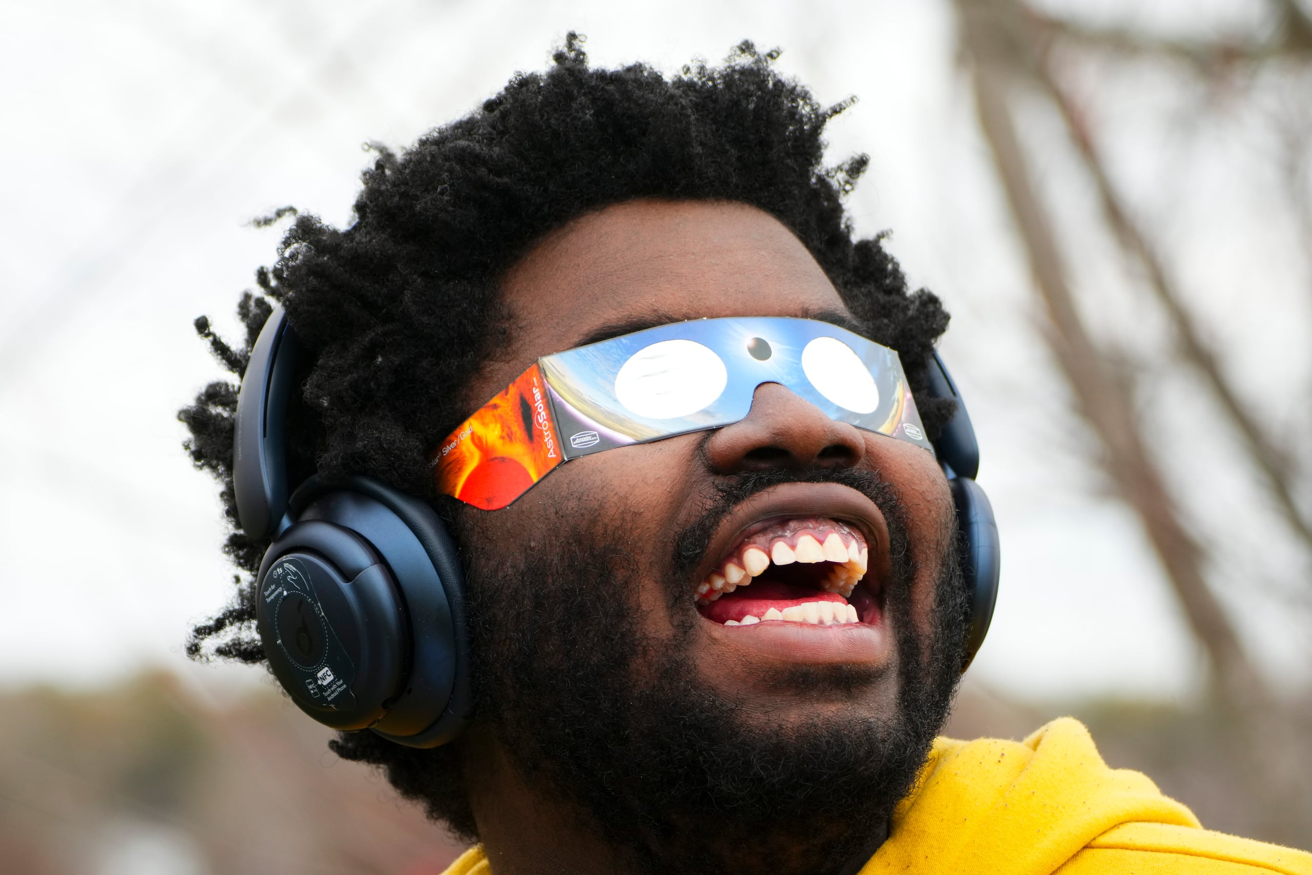 Un hombre utiliza unos anteojos especiales para ver el eclipse. (Sean Kilpatrick/The Canadian Press via AP)