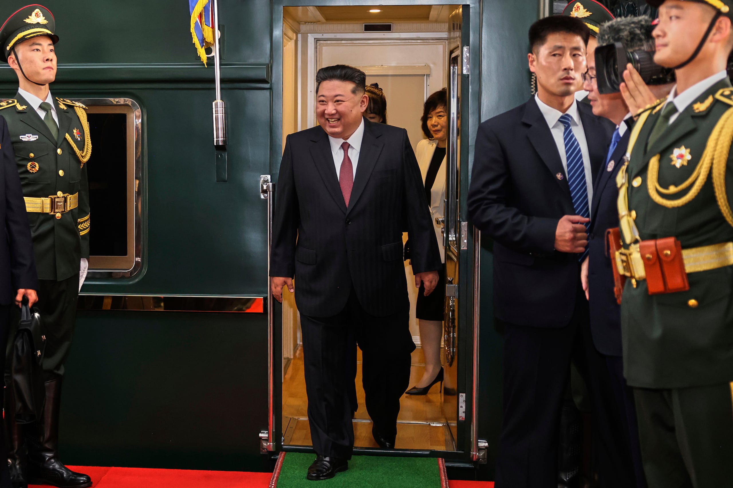 In this photo released by Xinhua News Agency, North Korea leader Kim Jong Un, center, disembarks from a train as he arrives at a railway station, in Beijing, China, Tuesday, Sept. 2, 2025. (Pang Xinglei/Xinhua via AP)