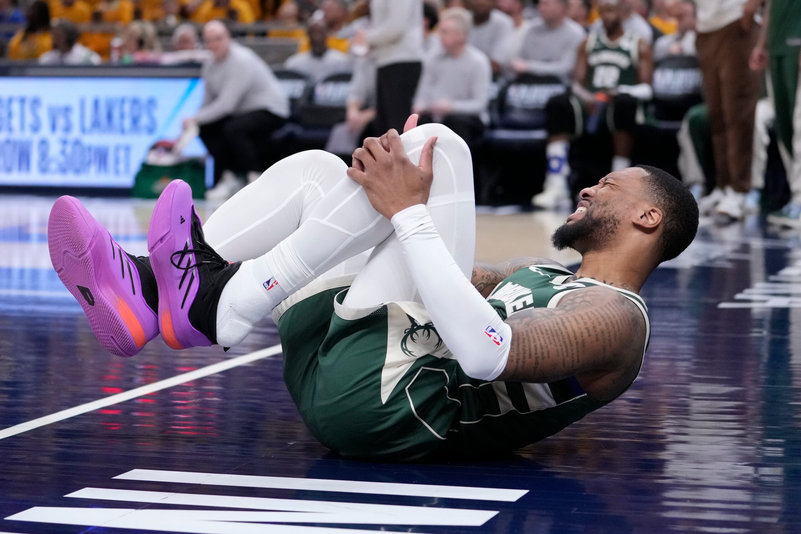 Damian Lillard se retuerce de dolor en el tabloncillo en una jugada del partido del pasado viernes que le hará perderse también el juego de hoy domingo.