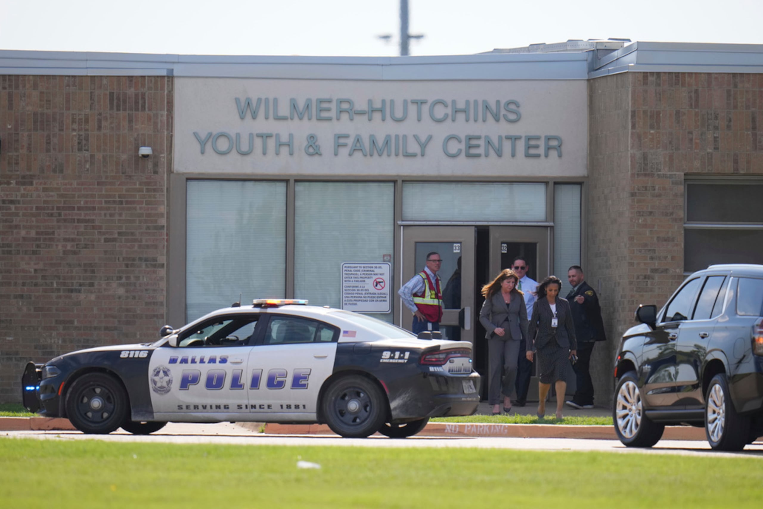 La superintendente Stephanie Elizalde, al centro a la izquierda, sale del centro juvenil y familiar de la escuela superior Wilmer-Hutchins después de que las autoridades informaran que el plantel había sido asegurado tras reportes de un tiroteo, en Dallas, Texas, el martes.