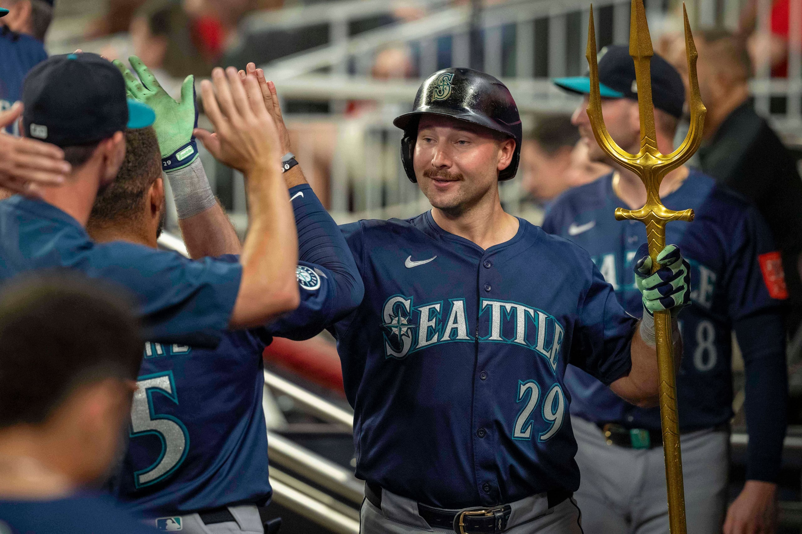 Cal Raleigh (29), con tridente en mano, celebra su jonrón en la novena entrada contra los Braves.
