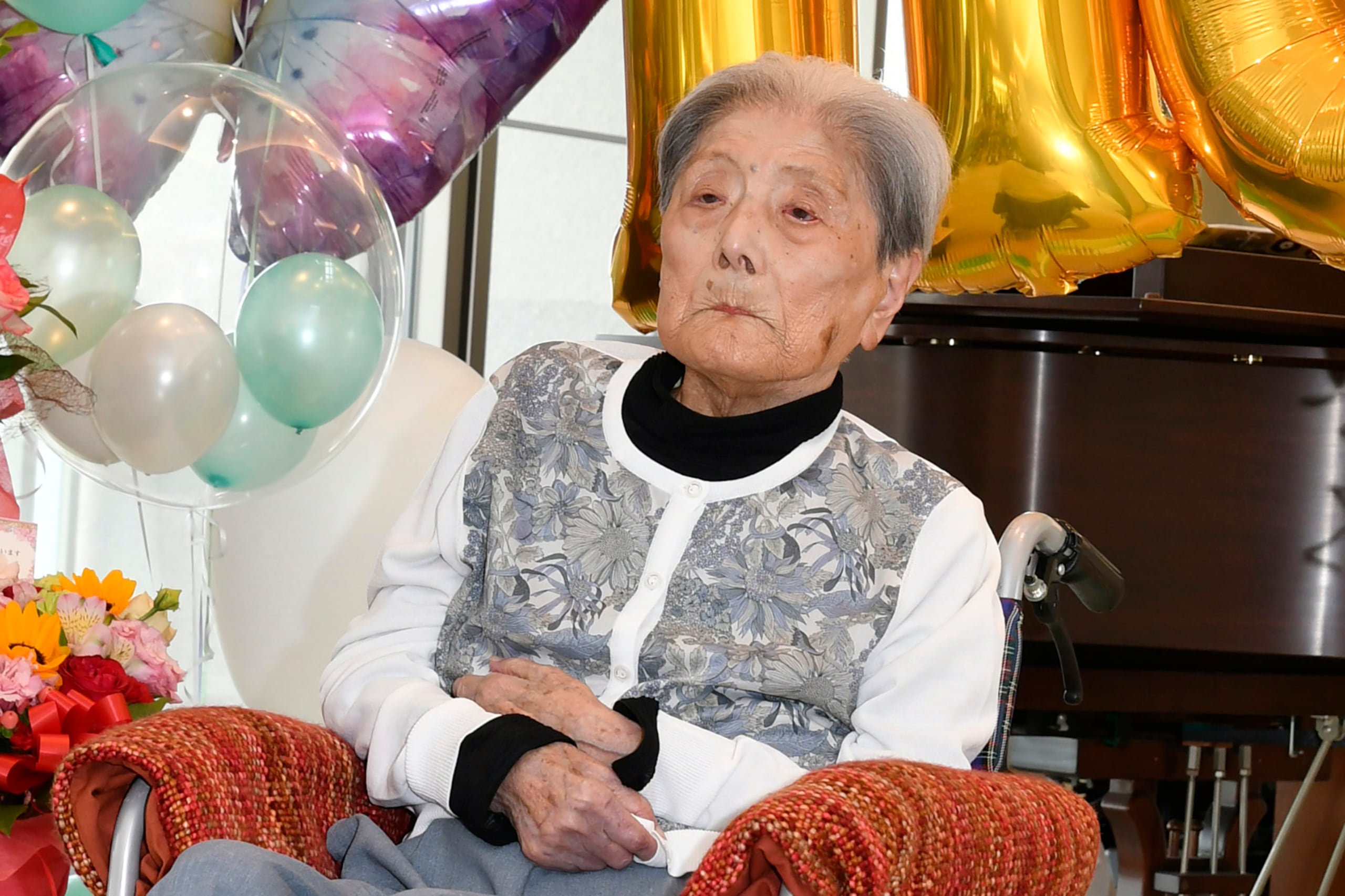 This photo provided by the city of Ashiya shows Tomiko Itooka, being celebrated for her 116th birthday at the nursing home she lives in Ashiya, western Japan, on May 23, 2024. (City of Ashiya via AP)