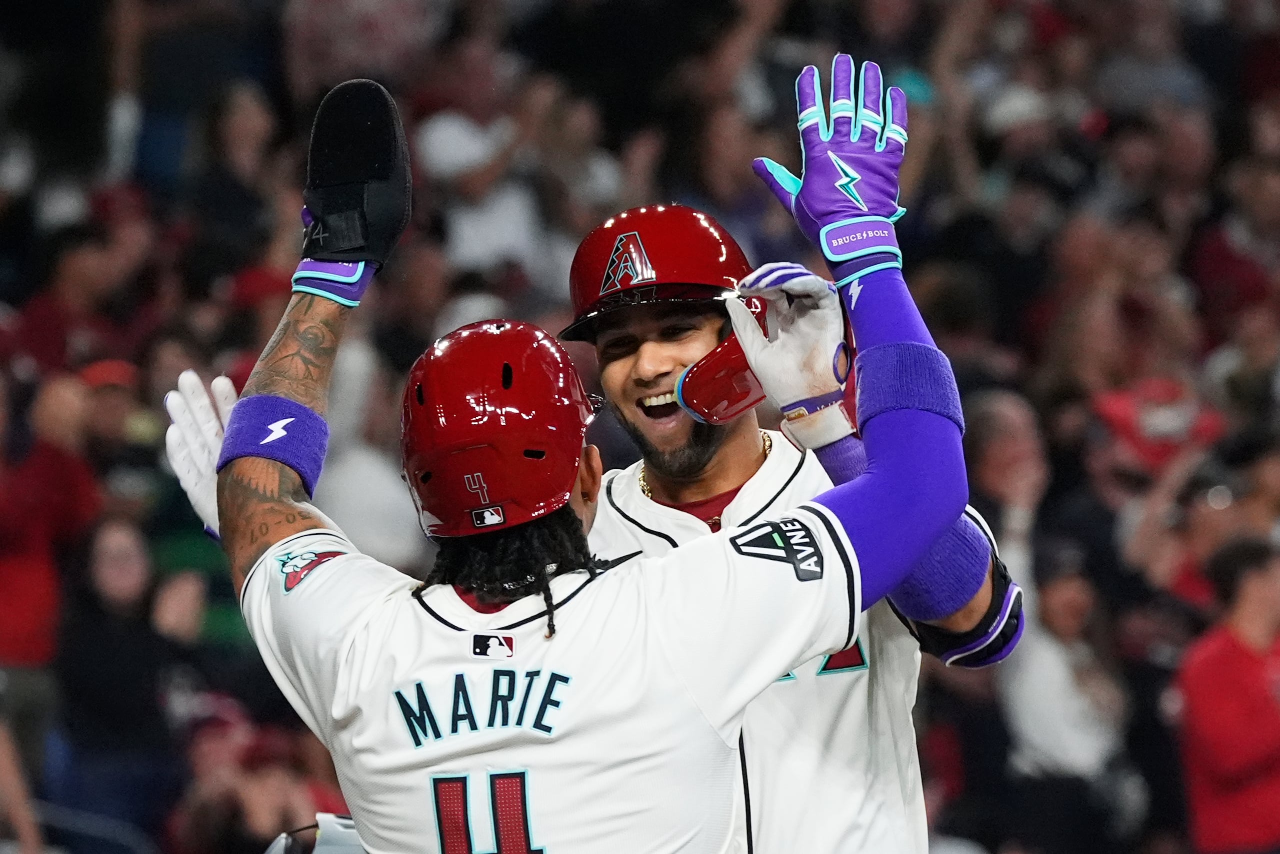 El cubano Lourdes Gurriel Jr. festeja con el dominicano Ketel Marte, su compañero en los Diamondbacks de Arizona, luego de batear un jonrón de dos carreras ante los Rockies de Colorado.