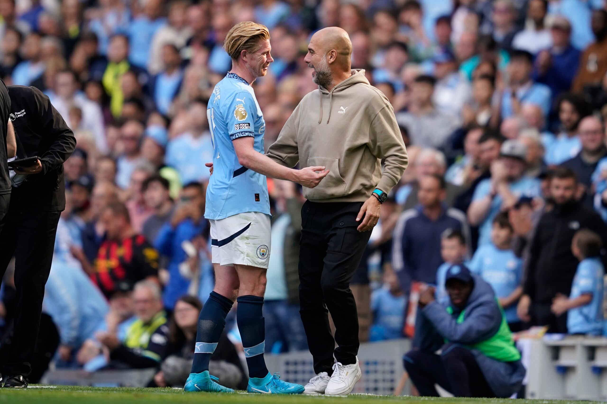 El entrenador del Manchester City, Pep Guardiola, habla con Kevin De Bruyne después de ser suplente durante el partido de fútbol de la Premier League inglesa entre el Manchester City y el Ipswich Town en el Etihad Stadium en Manchester, Inglaterra, el sábado 24 de agosto de 2024. (AP Foto/Dave Thompson)