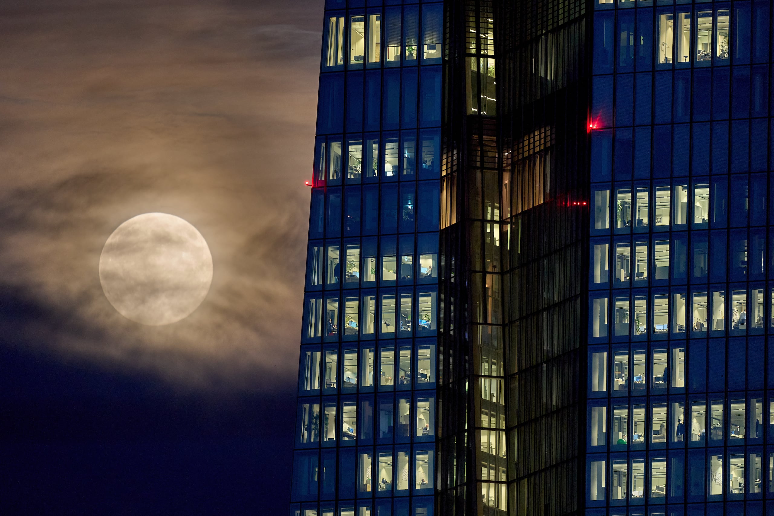 The beaver moon rises next to the European Central Bank in Frankfurt, Germany, Wednesday, Nov. 5, 2025. (AP Photo/Michael Probst)