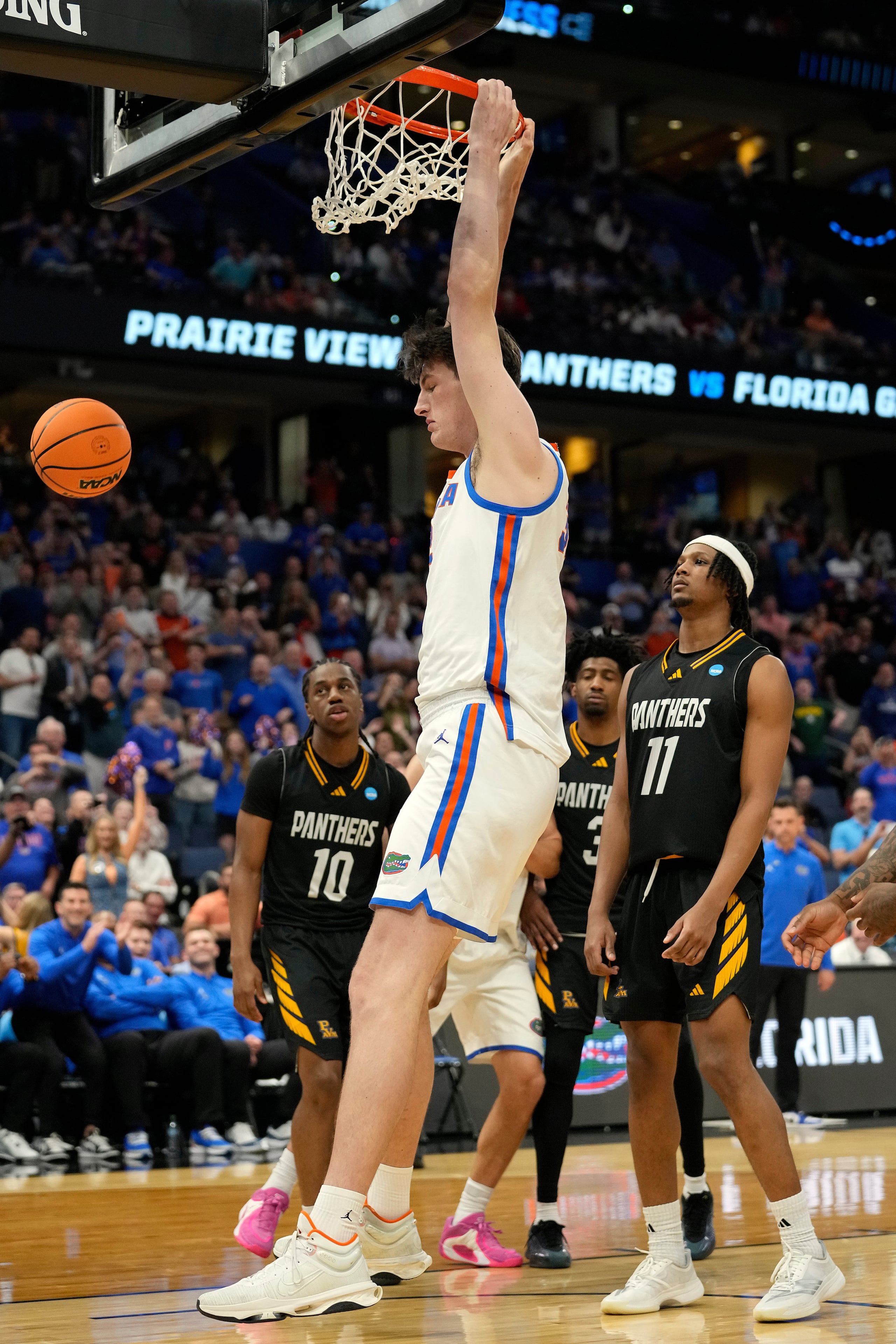 Florida center Olivier Rioux (32) follows through on his dunk over Prairie View A M guard Jannoy Thomas (10) and forward Hassane Diallo (11) during the second half in the first round of the NCAA college basketball tournament Friday, March 20, 2026, in Tampa, Fla. (AP Photo/Chris O'Meara)