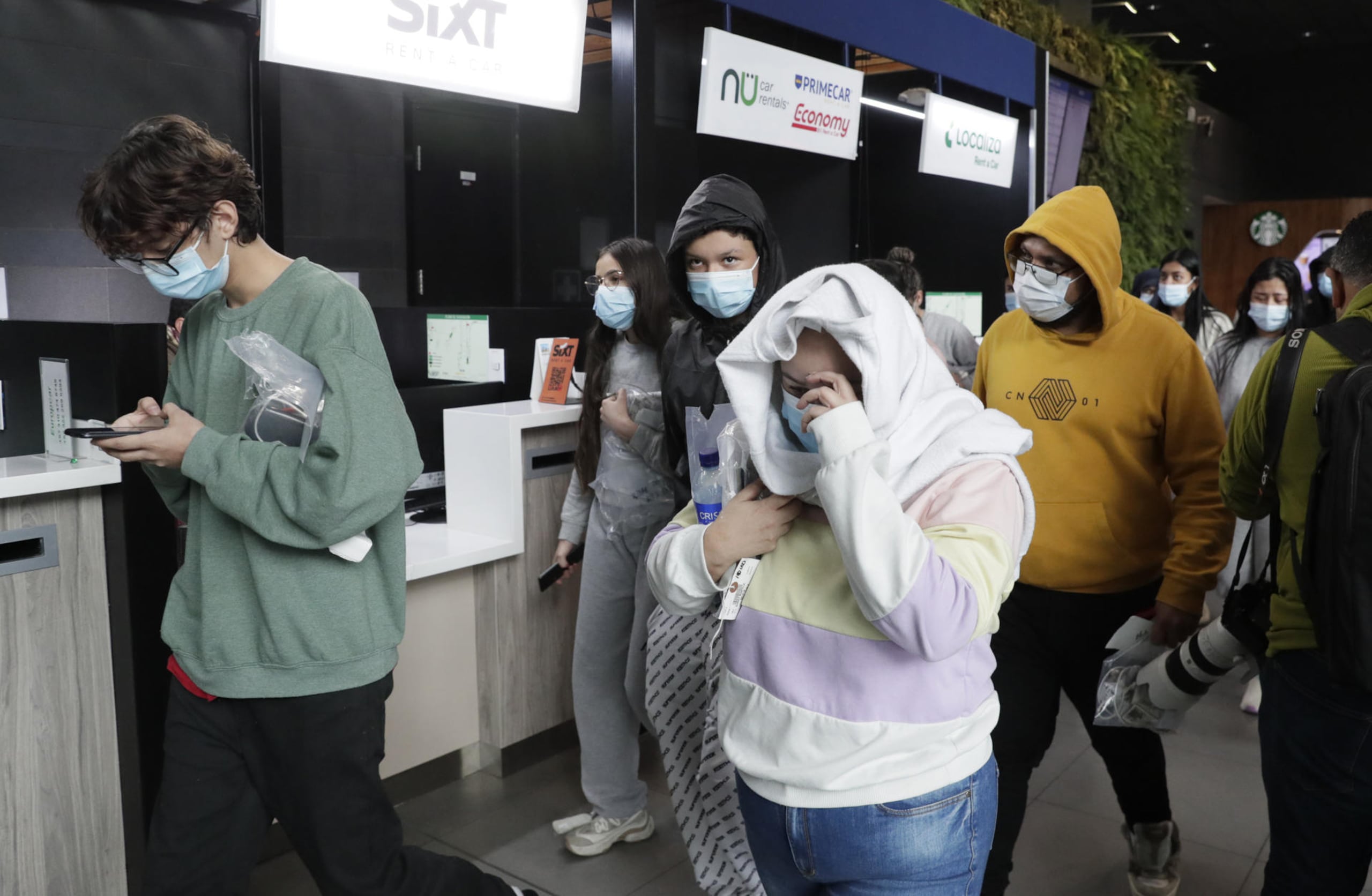Ciudadanos colombianos deportados de Estados Unidos caminan en el aeropuerto internacional El Dorado este martes, en Bogotá, Colombia.