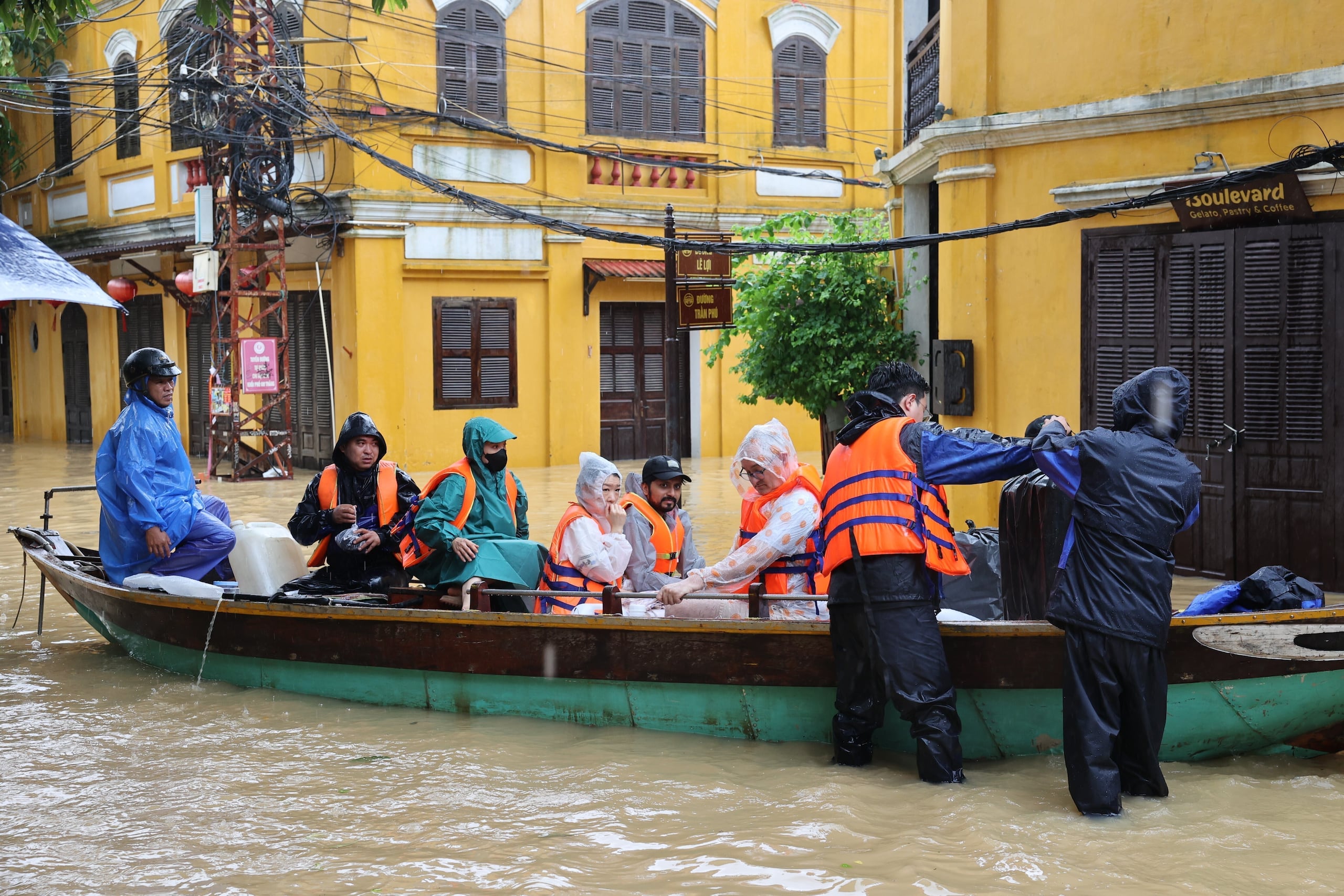 Tourists are evacuated by boat from flooding in Hoi An, Vietnam, Tuesday, Oct. 28, 2025. (Phan Anh Dung/VNA via AP)