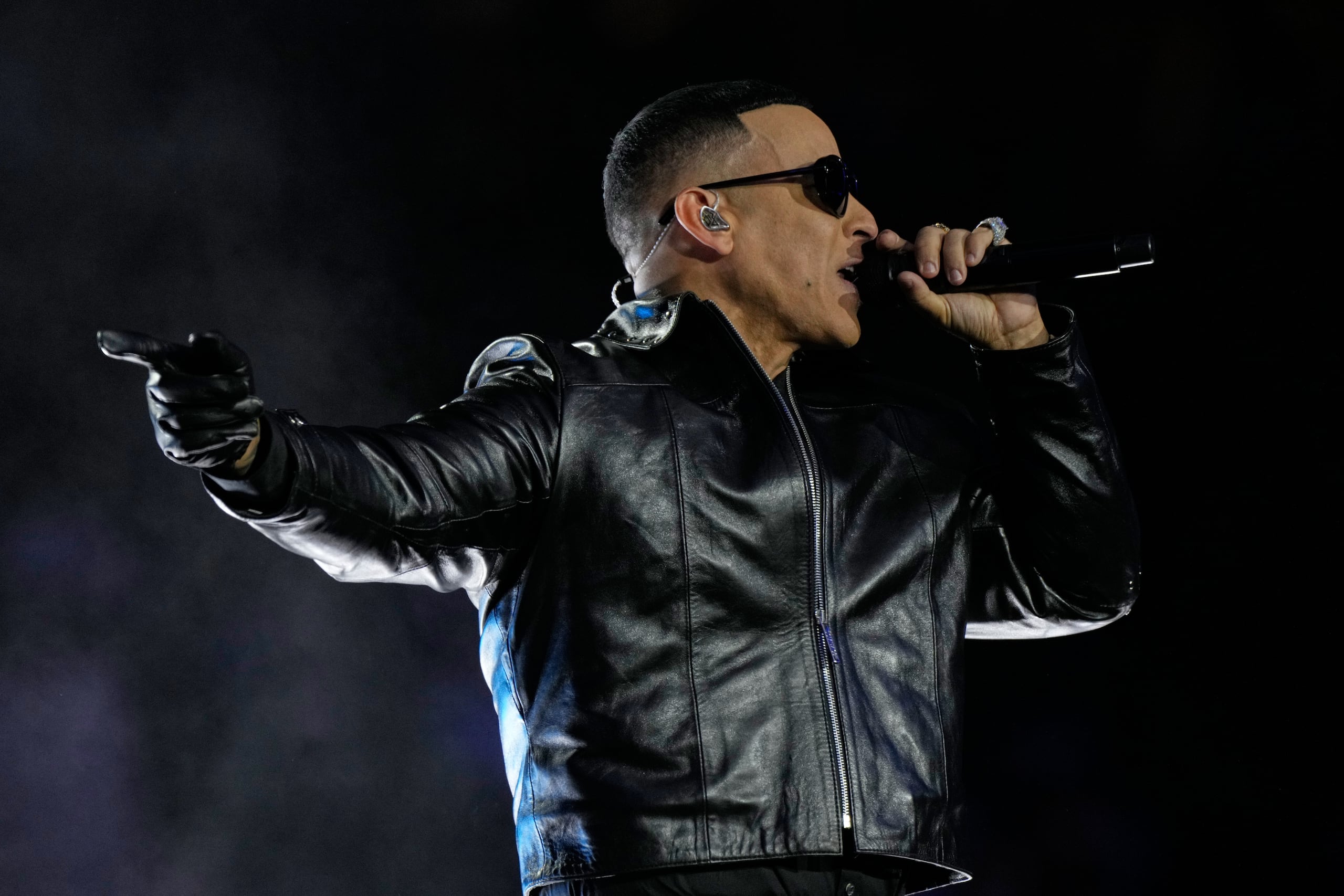 Daddy Yankee performs during the halftime show of an NFL football game between the Washington Commanders and the Miami Dolphins in Madrid, Spain, Sunday, Nov. 16, 2025. (AP Photo/Bernat Armangue)