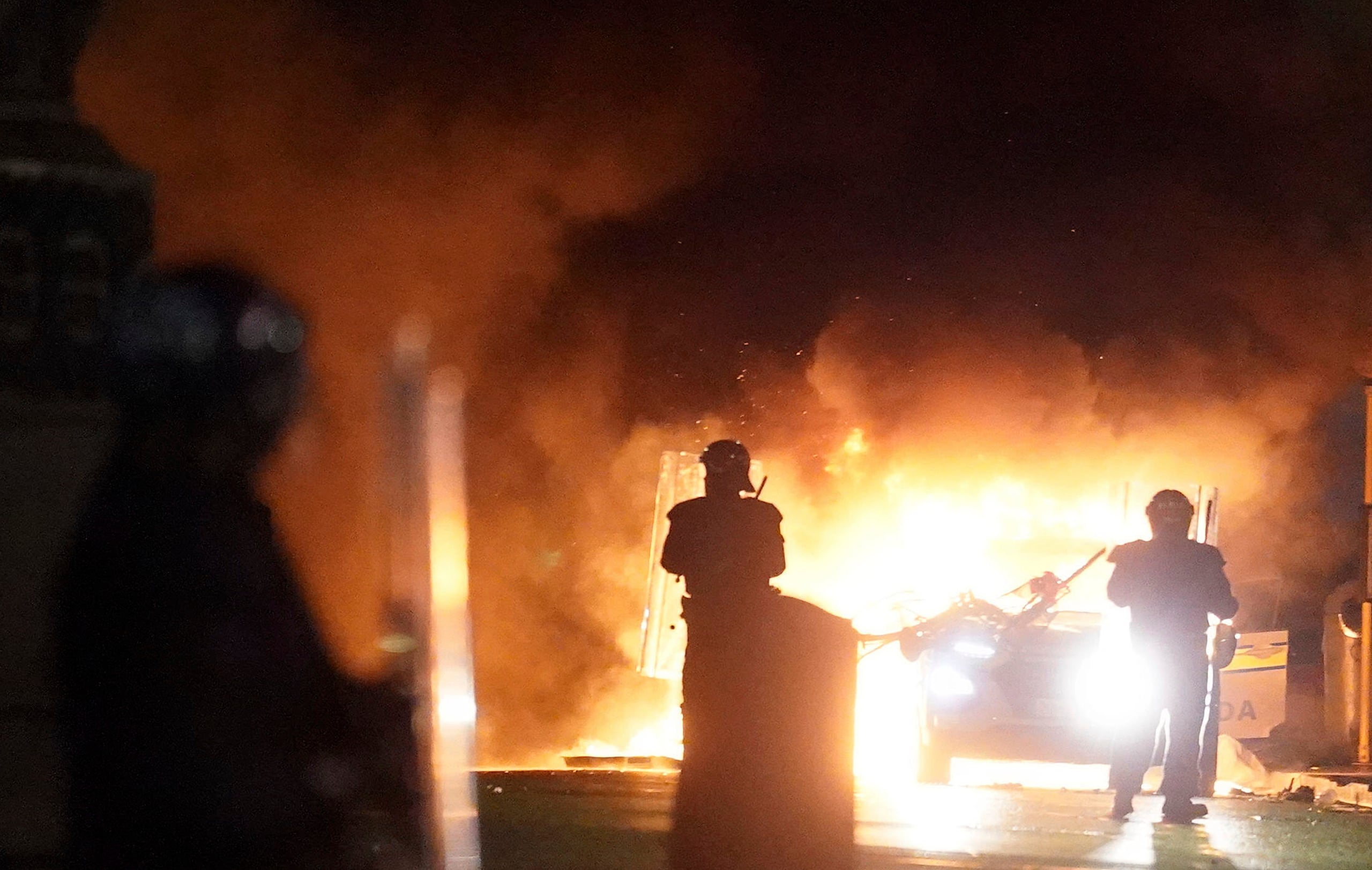 Varios vehículos policiales y un tranvía resultaron dañados durante los disturbios en el centro de la ciudad.