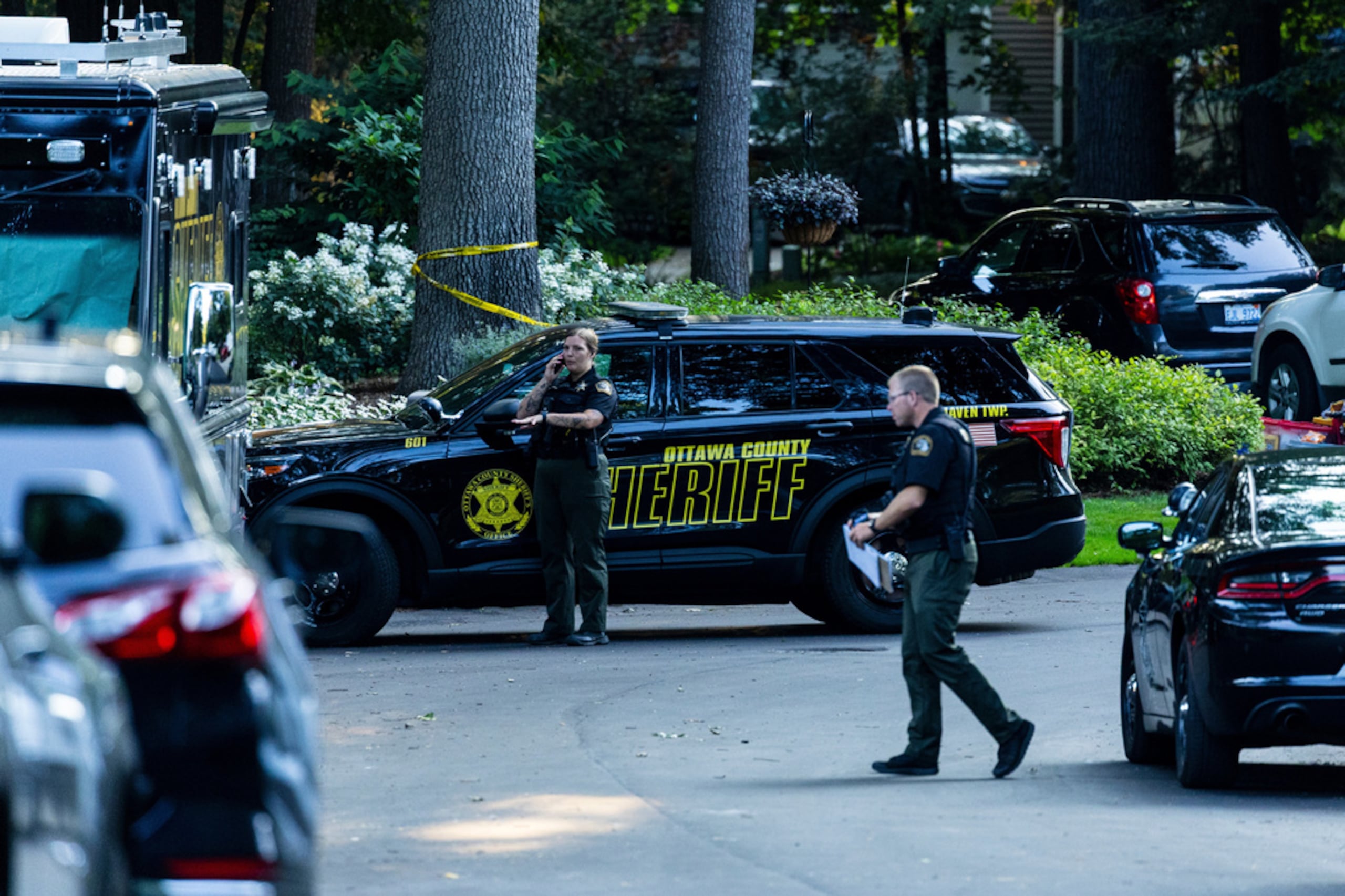 Law enforcement investigate the scene of a fatal house fire on Friday, July 24, 2026, in the in Grand Haven Township, Mich. Ottawa County Sheriff's Office said six children and two adults were found dead in a "suspicious" house fire. (Joel Bissell/Kalamazoo Gazette via AP)
