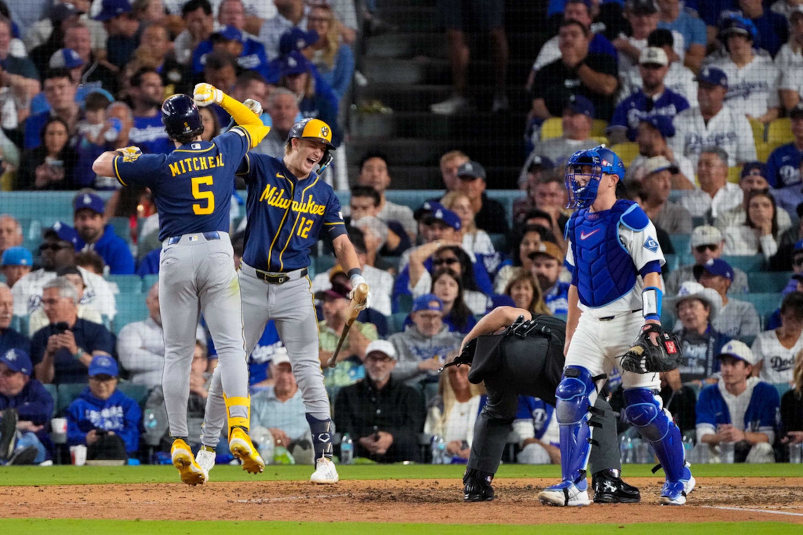 Garrett Mitchell celebra junto a Cooper Pratt tras conectar un jonrón solitario durante la séptima entrada del tercer juego de la Serie de Campeonato de la Liga Nacional entre los Cerveceros y los Dodgers el miércoles en Los Ángeles.