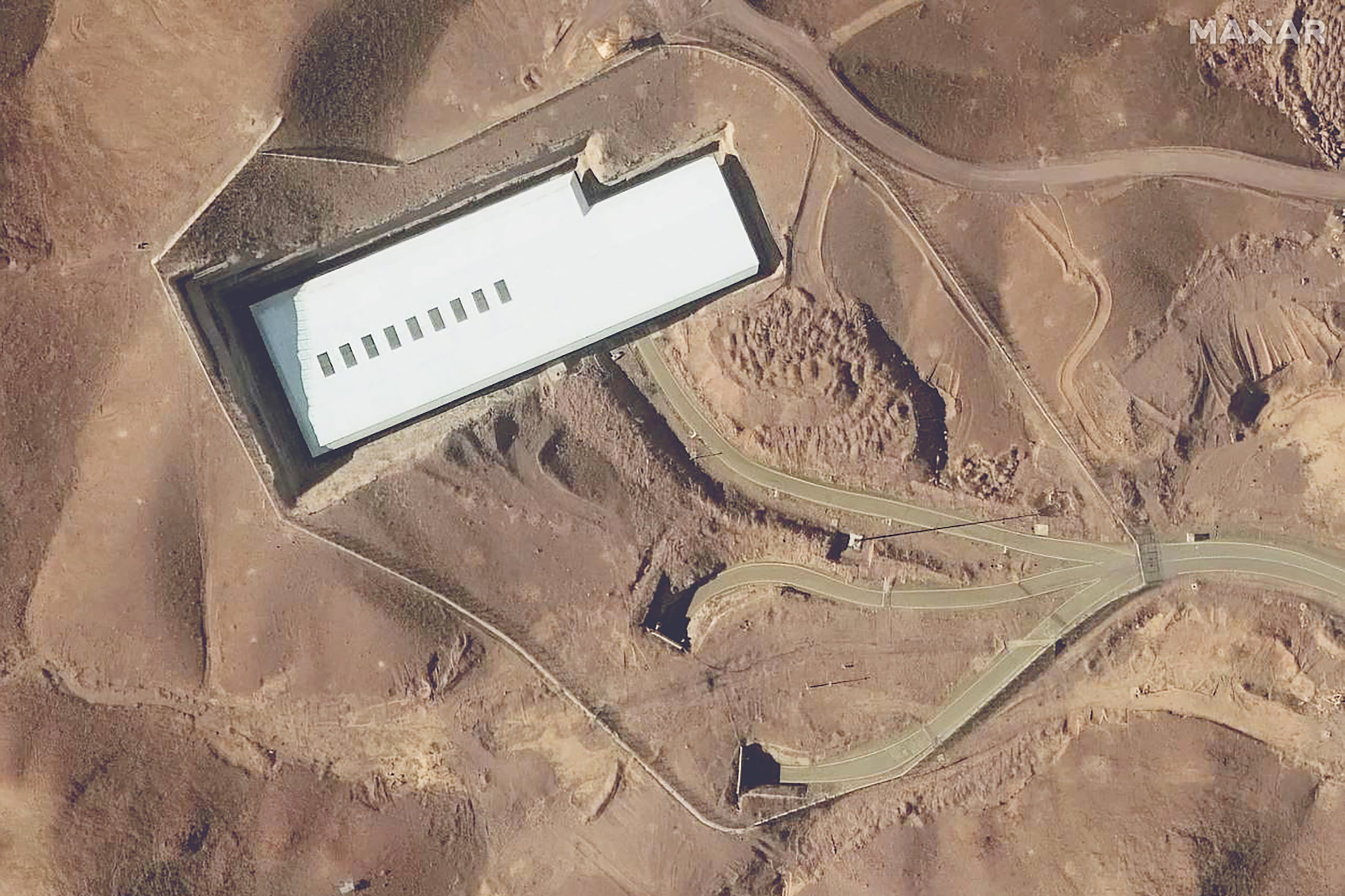 (FILES) This handout satellite image provided by Maxar Technologies and taken on February 12, 2025 shows an overview of the Fordo (Fordow) uranium enrichment facility, south of the capital Tehran. US President Donald Trump said June 21, 2025 the US military has carried out a "very successful attack" on three Iranian nuclear sites, including the underground uranium enrichment facility at Fordow. (Photo by Satellite image �2025 Maxar Technologies / AFP) / RESTRICTED TO EDITORIAL USE - MANDATORY CREDIT "AFP PHOTO / SATELLITE IMAGE �2025 MAXAR TECHNOLOGIES " - NO MARKETING - NO ADVERTISING CAMPAIGNS - DISTRIBUTED AS A SERVICE TO CLIENTS - THE WATERMARK MAY NOT BE REMOVED/CROPPED / THE WATERMARK MAY NOT BE REMOVED/CROPPED