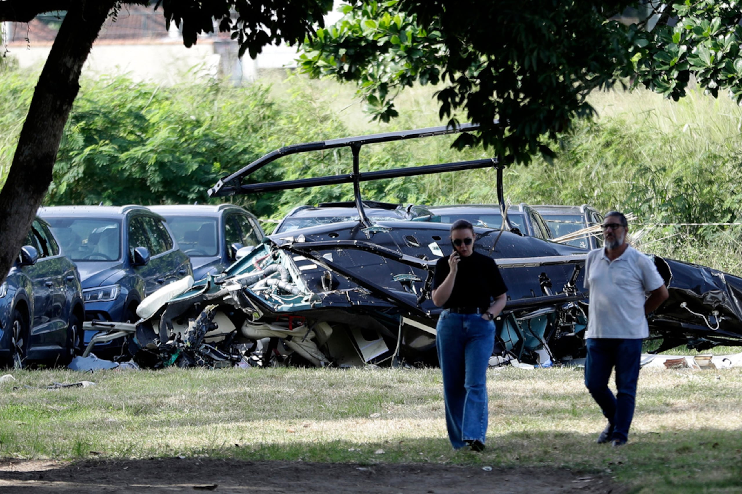 Helicopter wreckage lies at a car dealership parking lot where, according to police, two helicopters collided in midair and crashed in Rio de Janeiro, Brazil, Sunday, June 14, 2026. (AP Photo/Bruna Prado)